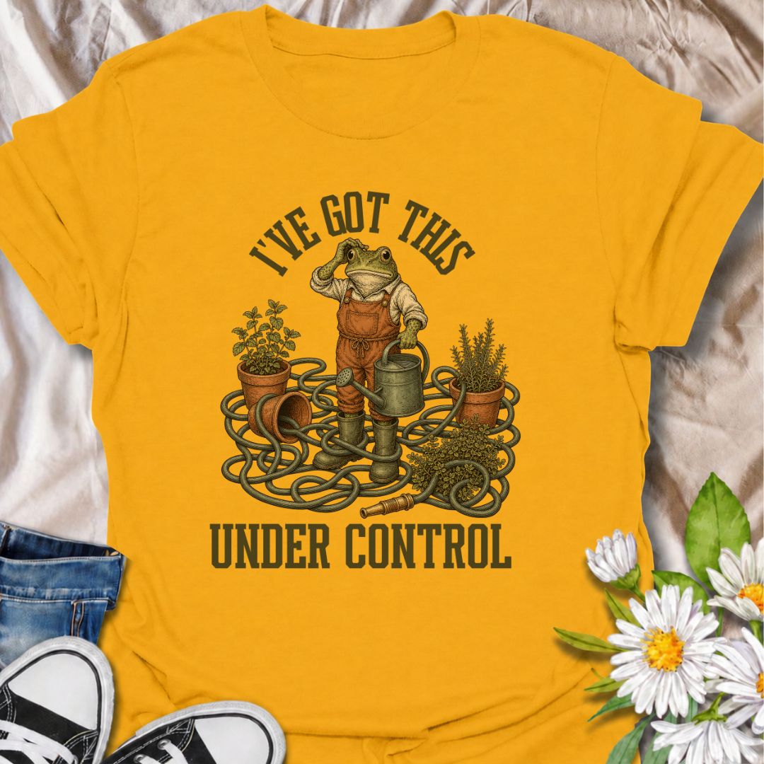 A funny gardening T-shirt for anyone who insists everything is completely under control, despite the evidence. Featuring a determined frog surrounded by tangled hose, pots, herbs, and garden tools, this design is perfect for gardeners who know chaos is part of the process. The phrase “I’ve Got This Under Control” adds dry, relatable humor without making the design feel too busy. It makes a great gift for backyard gardeners, plant lovers, and anyone who spends weekends wrestling with watering cans, hoses, an