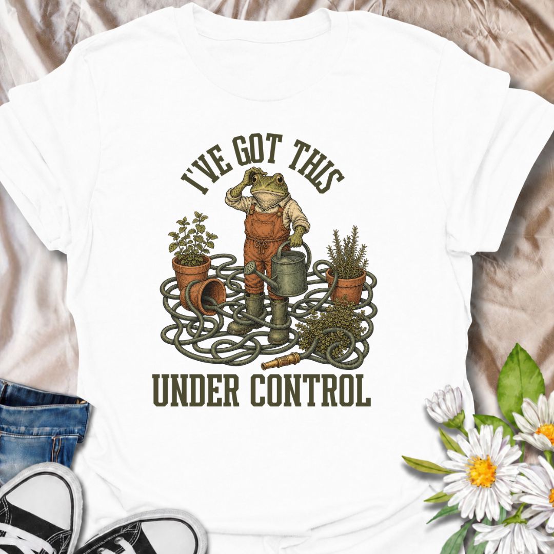 A funny gardening T-shirt for anyone who insists everything is completely under control, despite the evidence. Featuring a determined frog surrounded by tangled hose, pots, herbs, and garden tools, this design is perfect for gardeners who know chaos is part of the process. The phrase “I’ve Got This Under Control” adds dry, relatable humor without making the design feel too busy. It makes a great gift for backyard gardeners, plant lovers, and anyone who spends weekends wrestling with watering cans, hoses, an