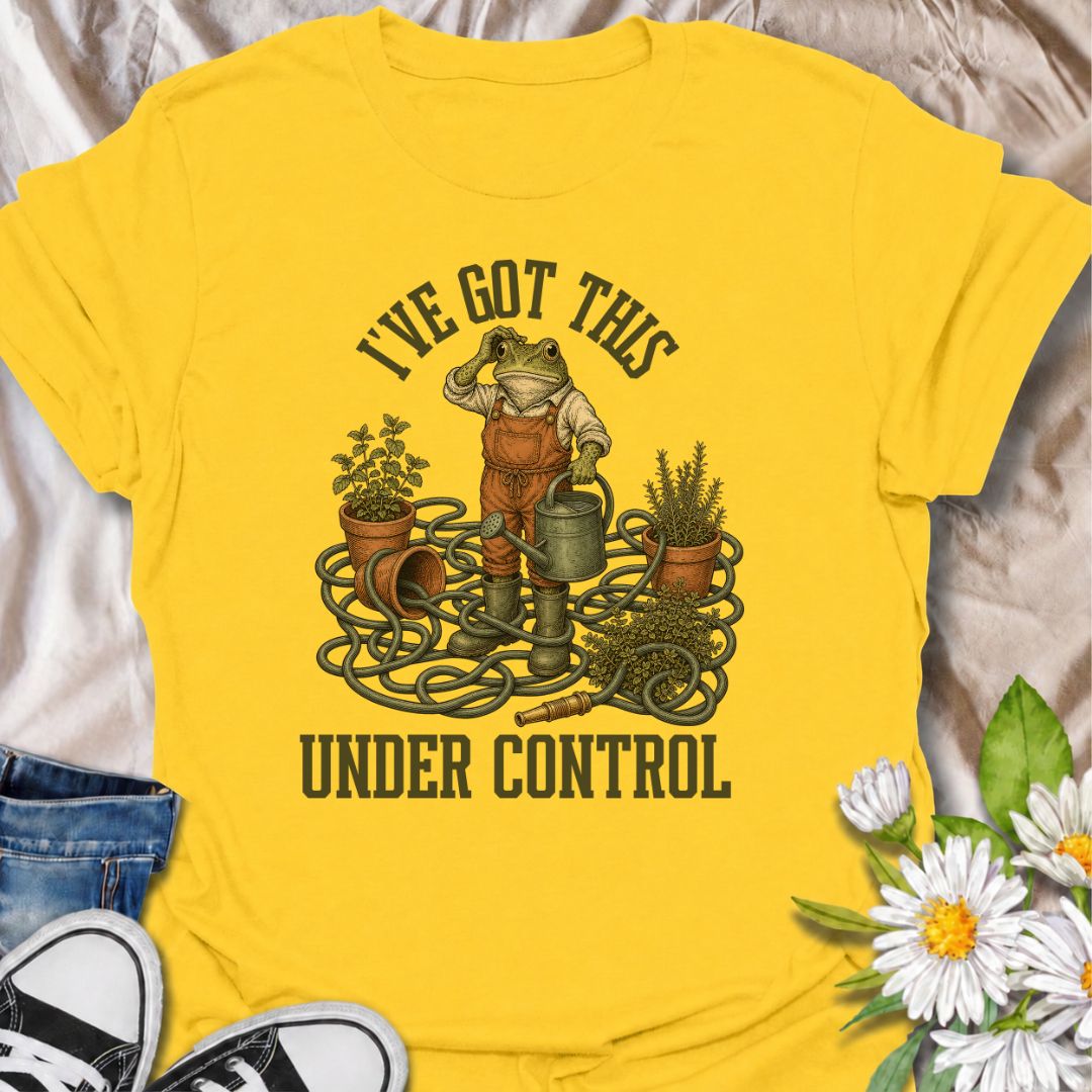 A funny gardening T-shirt for anyone who insists everything is completely under control, despite the evidence. Featuring a determined frog surrounded by tangled hose, pots, herbs, and garden tools, this design is perfect for gardeners who know chaos is part of the process. The phrase “I’ve Got This Under Control” adds dry, relatable humor without making the design feel too busy. It makes a great gift for backyard gardeners, plant lovers, and anyone who spends weekends wrestling with watering cans, hoses, an