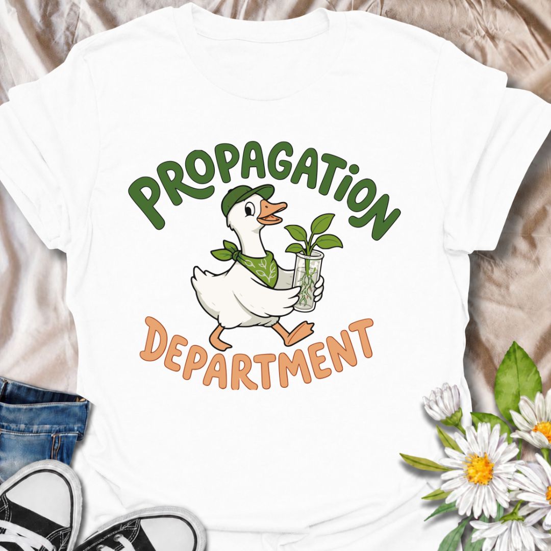 A funny propagation T-shirt for plant lovers who treat rooting cuttings like a proper department of operations. Featuring a cheerful goose carrying a fresh plant cutting in water, this design is perfect for houseplant collectors, plant parents, and propagation fans. The “Propagation Department” phrase gives the design a playful club-style feel without losing its clean, easy-to-read look. It makes a great gift for pothos lovers, indoor gardeners, and anyone with jars of cuttings taking over the counter. Idea