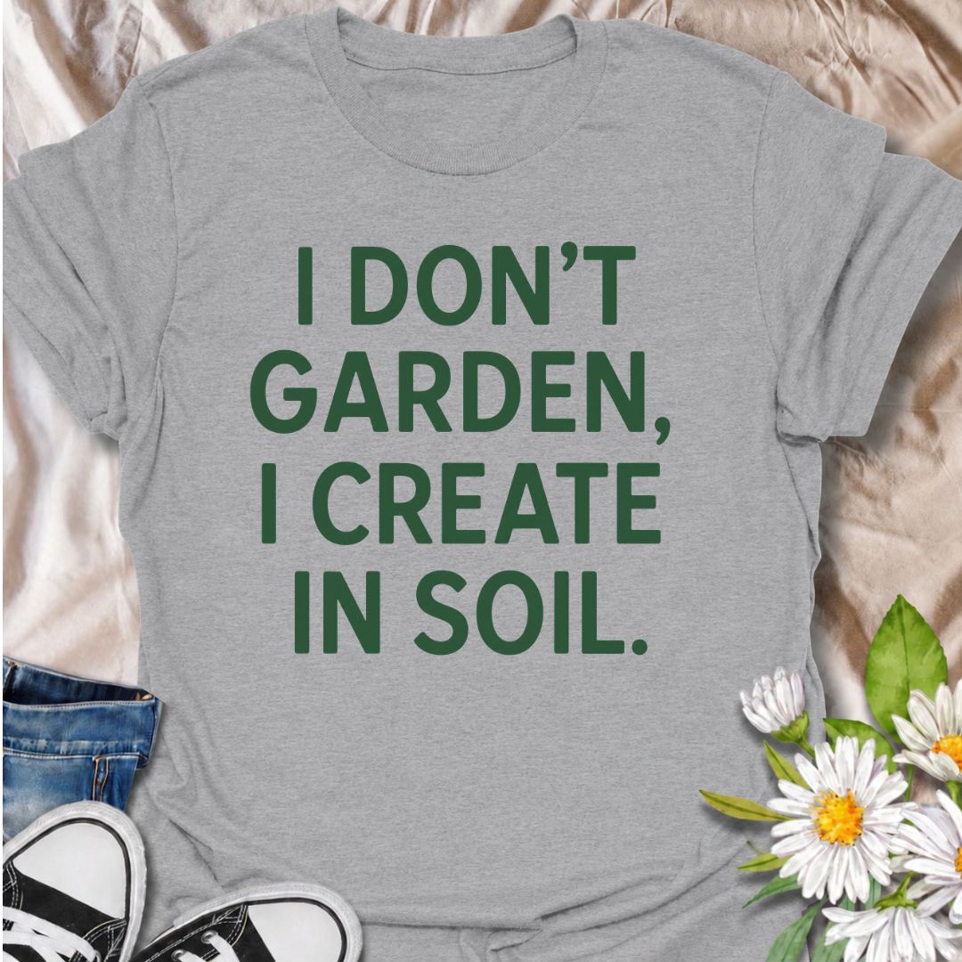 A bold gardening T-shirt for anyone who sees the garden as a place to make, experiment, and grow. The phrase “I Don’t Garden, I Create in Soil” gives gardening a more creative, expressive twist while keeping the design clean and modern. It is perfect for gardeners, plant lovers, backyard growers, and anyone who treats planting as their favorite form of creativity. The simple typography makes it easy to wear and easy to pair with everyday outfits. A great gift for gardeners who see soil as their canvas.