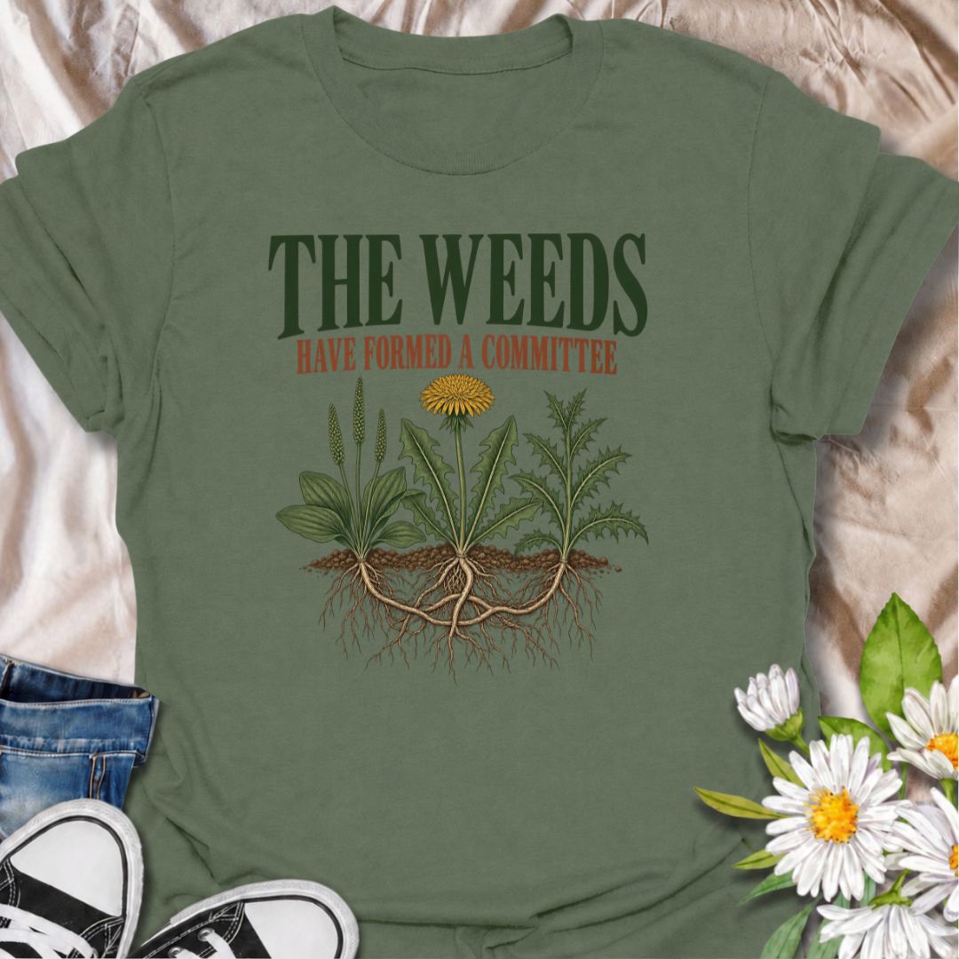 A funny gardening T-shirt for anyone who knows the weeds are never working alone. The phrase “The Weeds Have Formed a Committee” turns a familiar gardening frustration into dry, relatable humor. Featuring a cluster of weeds with tangled roots, this design is perfect for backyard gardeners, allotment growers, and anyone who spends more time weeding than planned. It makes a great gift for gardeners who appreciate clever garden humor and know just how persistent weeds can be. Ideal for garden days, nursery tri