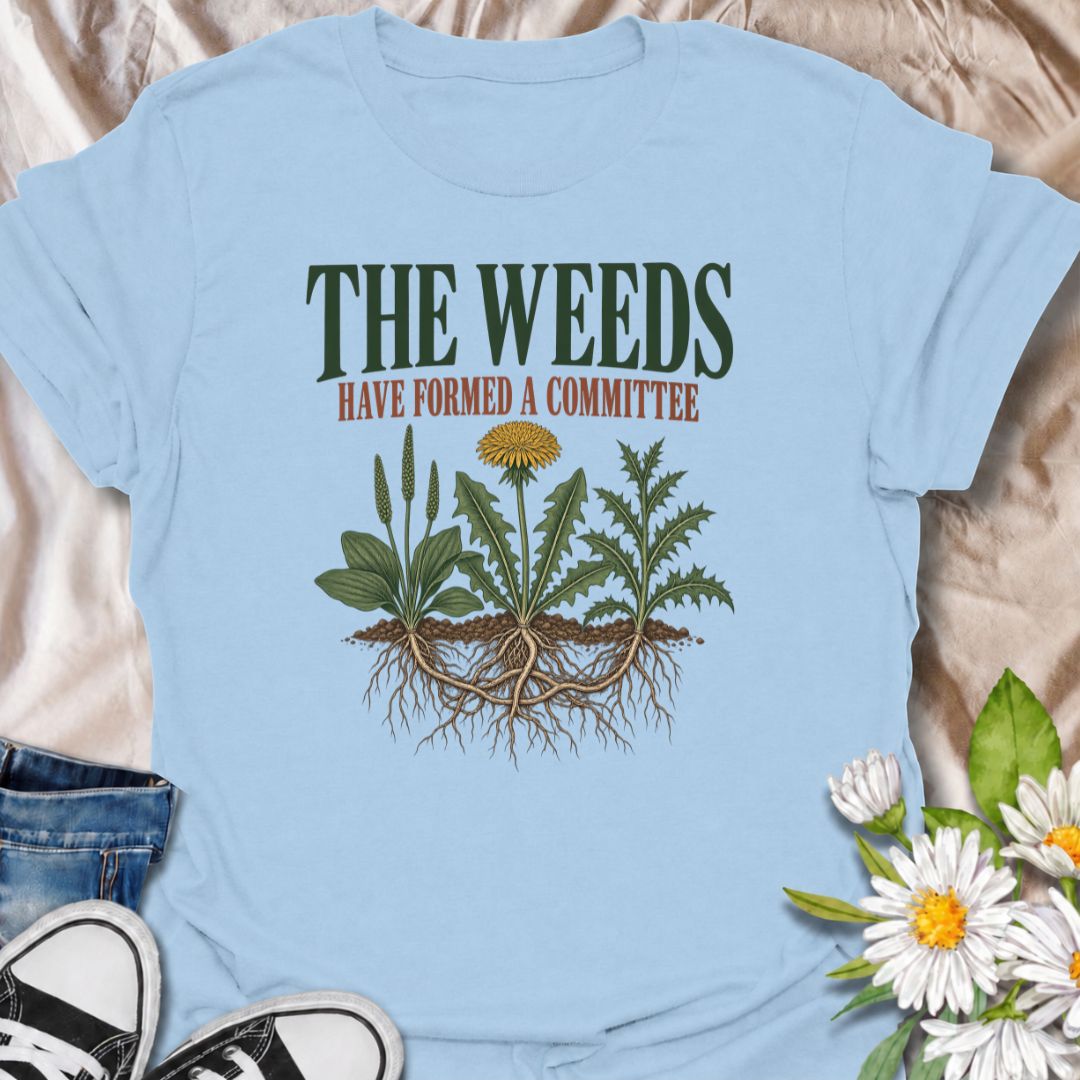 A funny gardening T-shirt for anyone who knows the weeds are never working alone. The phrase “The Weeds Have Formed a Committee” turns a familiar gardening frustration into dry, relatable humor. Featuring a cluster of weeds with tangled roots, this design is perfect for backyard gardeners, allotment growers, and anyone who spends more time weeding than planned. It makes a great gift for gardeners who appreciate clever garden humor and know just how persistent weeds can be. Ideal for garden days, nursery tri