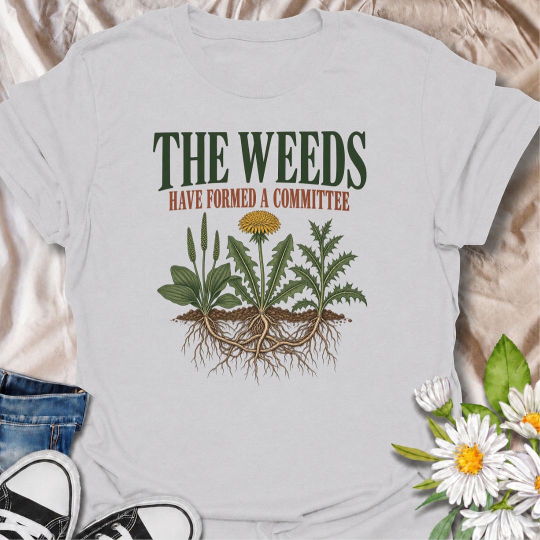 A funny gardening T-shirt for anyone who knows the weeds are never working alone. The phrase “The Weeds Have Formed a Committee” turns a familiar gardening frustration into dry, relatable humor. Featuring a cluster of weeds with tangled roots, this design is perfect for backyard gardeners, allotment growers, and anyone who spends more time weeding than planned. It makes a great gift for gardeners who appreciate clever garden humor and know just how persistent weeds can be. Ideal for garden days, nursery tri