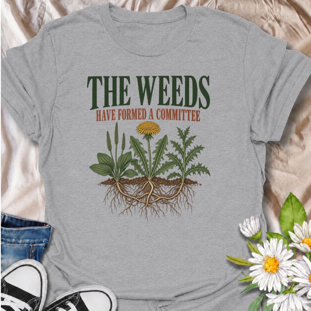 A funny gardening T-shirt for anyone who knows the weeds are never working alone. The phrase “The Weeds Have Formed a Committee” turns a familiar gardening frustration into dry, relatable humor. Featuring a cluster of weeds with tangled roots, this design is perfect for backyard gardeners, allotment growers, and anyone who spends more time weeding than planned. It makes a great gift for gardeners who appreciate clever garden humor and know just how persistent weeds can be. Ideal for garden days, nursery tri
