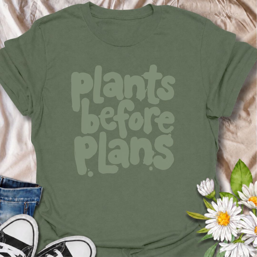 A funny plant T-shirt for anyone whose priorities are clear: plants first, plans later. The phrase “Plants Before Plans” is simple, playful, and instantly relatable for houseplant lovers, plant parents, and indoor gardeners. Its chunky retro typography gives the design a casual, modern feel that is easy to wear. It makes a great gift for plant collectors, nursery regulars, and anyone who would happily cancel plans for a quiet day with their plants. Perfect for plant shopping, greenhouse visits, relaxed week