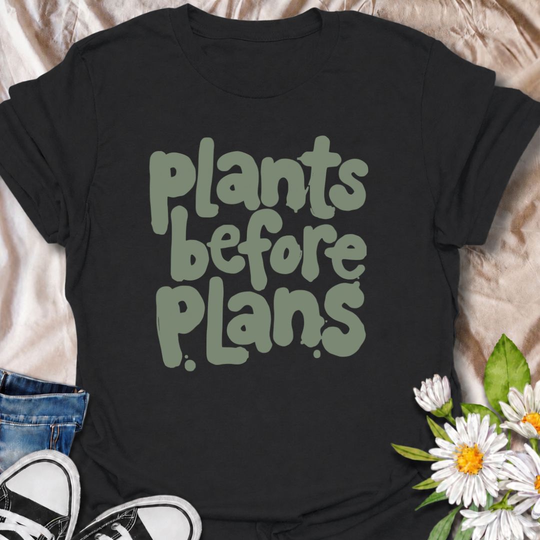 A funny plant T-shirt for anyone whose priorities are clear: plants first, plans later. The phrase “Plants Before Plans” is simple, playful, and instantly relatable for houseplant lovers, plant parents, and indoor gardeners. Its chunky retro typography gives the design a casual, modern feel that is easy to wear. It makes a great gift for plant collectors, nursery regulars, and anyone who would happily cancel plans for a quiet day with their plants. Perfect for plant shopping, greenhouse visits, relaxed week