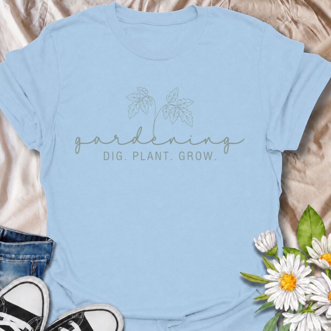 A simple gardening T-shirt for anyone who feels most at home with their hands in the soil. The understated “Gardening — Dig. Plant. Grow.” design combines delicate botanical line art with a clean, relaxed look. It is perfect for gardeners, plant lovers, backyard growers, and anyone who enjoys the quiet rhythm of planting and growing. The softer style makes it especially easy to wear while still clearly speaking to the gardening niche. A lovely gift for flower gardeners, vegetable growers, and anyone who wou