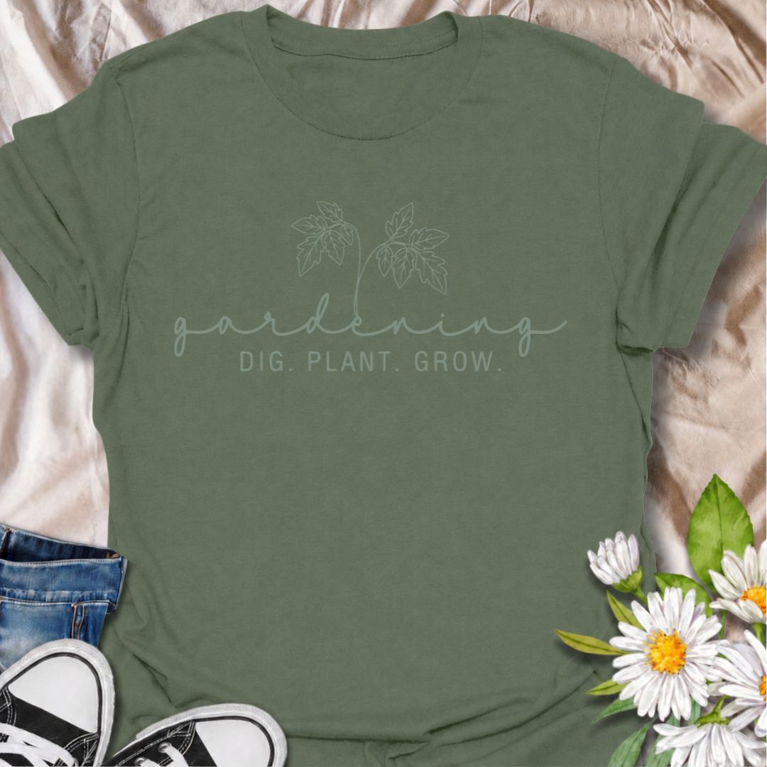 A simple gardening T-shirt for anyone who feels most at home with their hands in the soil. The understated “Gardening — Dig. Plant. Grow.” design combines delicate botanical line art with a clean, relaxed look. It is perfect for gardeners, plant lovers, backyard growers, and anyone who enjoys the quiet rhythm of planting and growing. The softer style makes it especially easy to wear while still clearly speaking to the gardening niche. A lovely gift for flower gardeners, vegetable growers, and anyone who wou