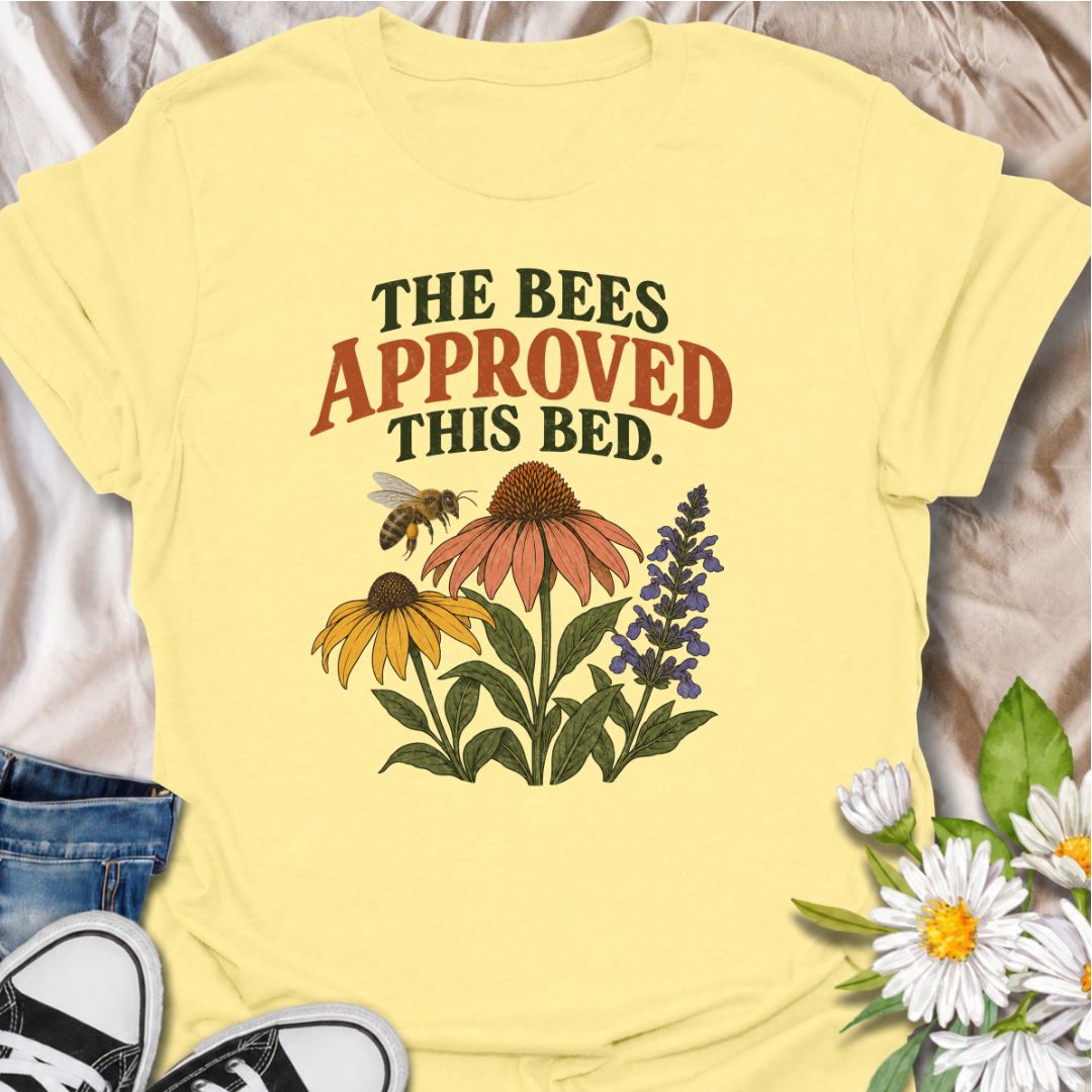 A cheerful gardening T-shirt for anyone who takes pride in growing flowers the pollinators love. The phrase “The Bees Approved This Bed” pairs perfectly with coneflowers, black-eyed Susans, salvia, and a visiting bee for a garden design with real pollinator appeal. It is ideal for flower gardeners, wildlife gardeners, native plant lovers, and anyone creating a bee-friendly backyard. The design makes a lovely gift for gardeners who enjoy supporting bees while filling their beds with color. Perfect for garden