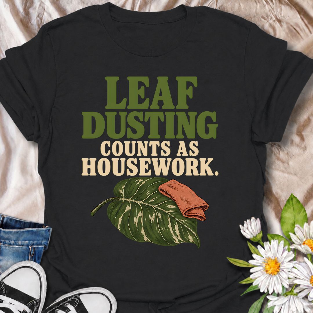 A funny houseplant T-shirt for anyone who insists that cleaning leaves absolutely counts as housework. The phrase “Leaf Dusting Counts as Housework” captures a very specific bit of plant-parent logic that houseplant lovers will instantly recognize. Featuring a large leafy plant and cleaning cloth, the design keeps the joke simple, niche, and easy to wear. It makes a great gift for plant collectors, indoor gardeners, and anyone who spends more time caring for leaves than doing ordinary chores. Ideal for plan
