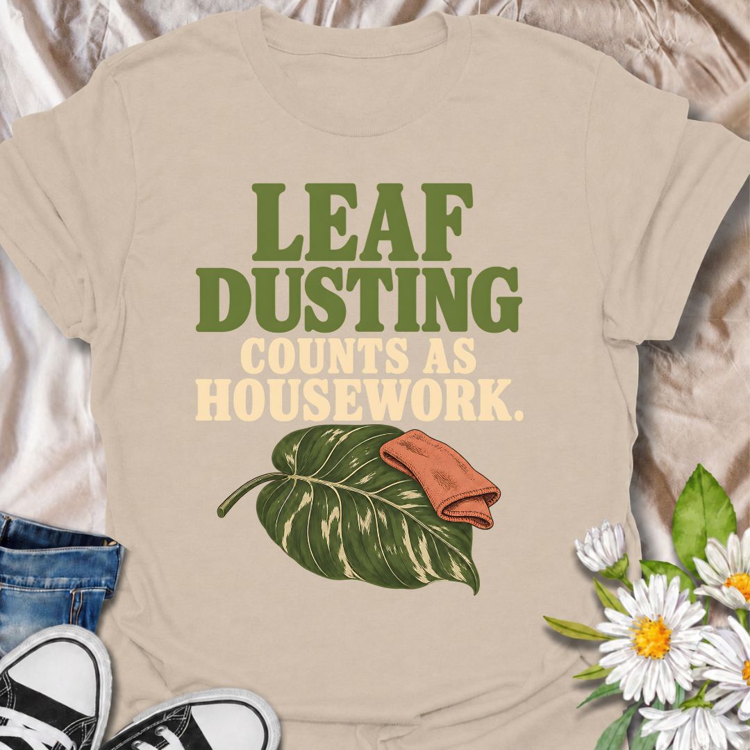 A funny houseplant T-shirt for anyone who insists that cleaning leaves absolutely counts as housework. The phrase “Leaf Dusting Counts as Housework” captures a very specific bit of plant-parent logic that houseplant lovers will instantly recognize. Featuring a large leafy plant and cleaning cloth, the design keeps the joke simple, niche, and easy to wear. It makes a great gift for plant collectors, indoor gardeners, and anyone who spends more time caring for leaves than doing ordinary chores. Ideal for plan