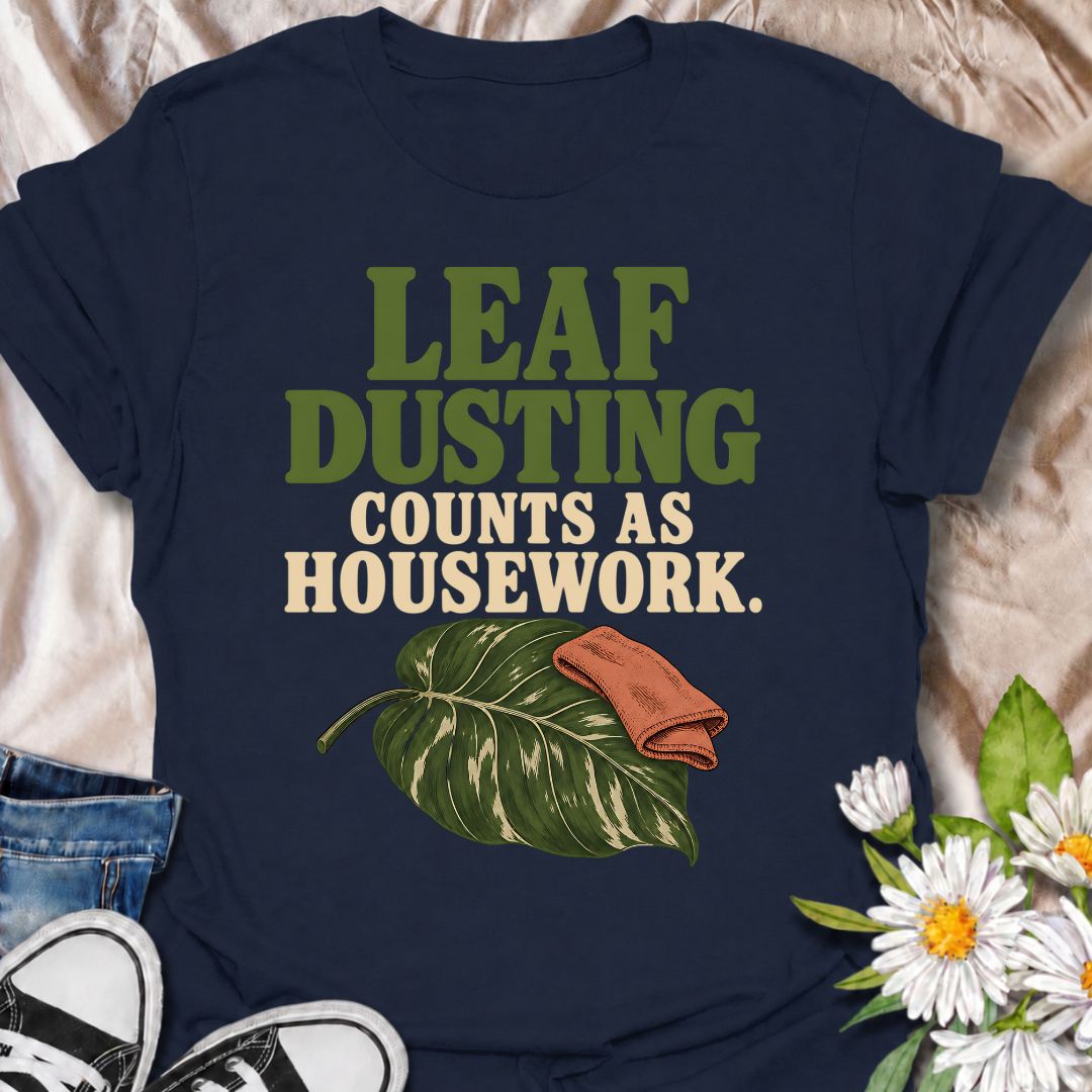 A funny houseplant T-shirt for anyone who insists that cleaning leaves absolutely counts as housework. The phrase “Leaf Dusting Counts as Housework” captures a very specific bit of plant-parent logic that houseplant lovers will instantly recognize. Featuring a large leafy plant and cleaning cloth, the design keeps the joke simple, niche, and easy to wear. It makes a great gift for plant collectors, indoor gardeners, and anyone who spends more time caring for leaves than doing ordinary chores. Ideal for plan