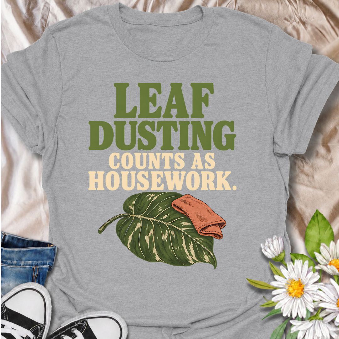 A funny houseplant T-shirt for anyone who insists that cleaning leaves absolutely counts as housework. The phrase “Leaf Dusting Counts as Housework” captures a very specific bit of plant-parent logic that houseplant lovers will instantly recognize. Featuring a large leafy plant and cleaning cloth, the design keeps the joke simple, niche, and easy to wear. It makes a great gift for plant collectors, indoor gardeners, and anyone who spends more time caring for leaves than doing ordinary chores. Ideal for plan