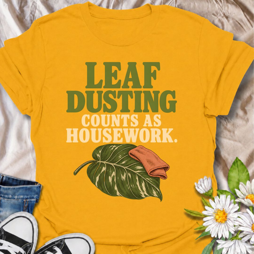 A funny houseplant T-shirt for anyone who insists that cleaning leaves absolutely counts as housework. The phrase “Leaf Dusting Counts as Housework” captures a very specific bit of plant-parent logic that houseplant lovers will instantly recognize. Featuring a large leafy plant and cleaning cloth, the design keeps the joke simple, niche, and easy to wear. It makes a great gift for plant collectors, indoor gardeners, and anyone who spends more time caring for leaves than doing ordinary chores. Ideal for plan