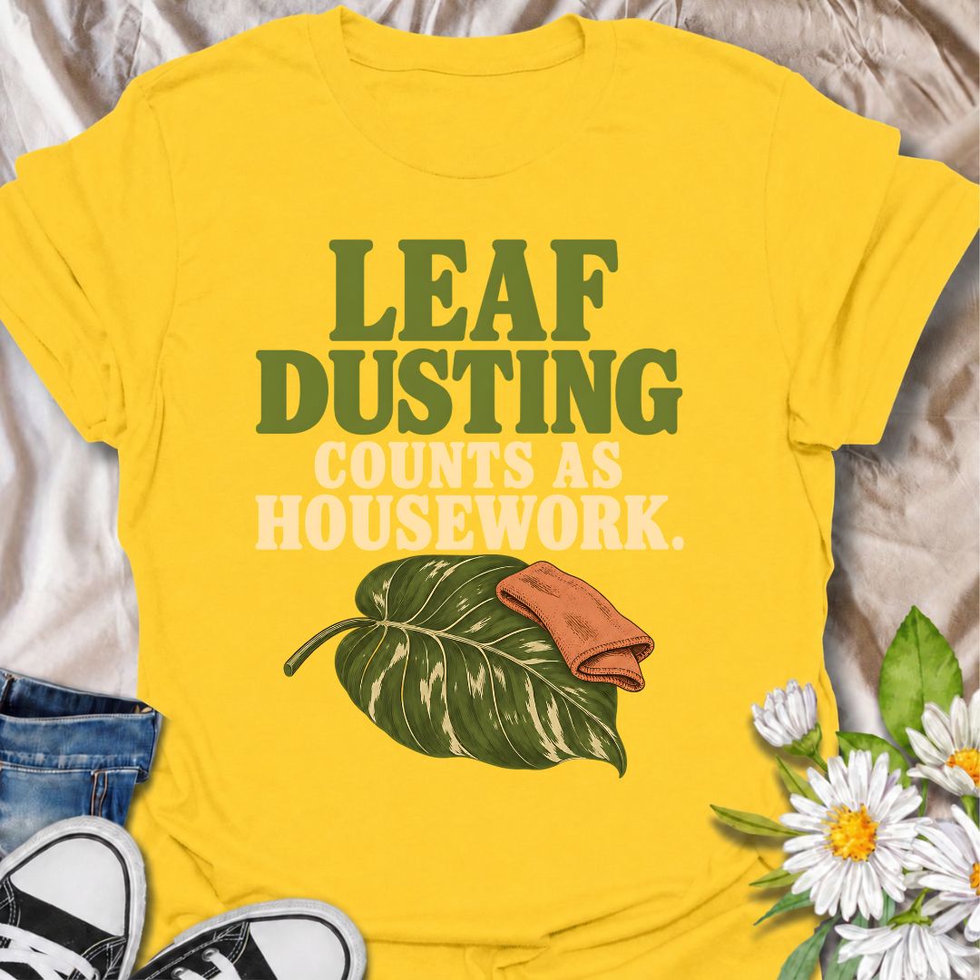 A funny houseplant T-shirt for anyone who insists that cleaning leaves absolutely counts as housework. The phrase “Leaf Dusting Counts as Housework” captures a very specific bit of plant-parent logic that houseplant lovers will instantly recognize. Featuring a large leafy plant and cleaning cloth, the design keeps the joke simple, niche, and easy to wear. It makes a great gift for plant collectors, indoor gardeners, and anyone who spends more time caring for leaves than doing ordinary chores. Ideal for plan