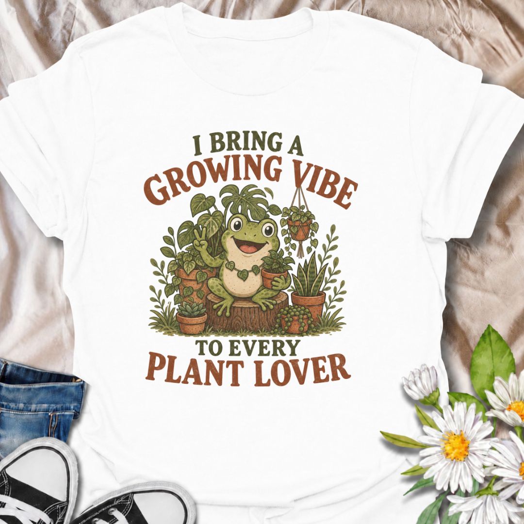 A playful plant T-shirt for anyone who brings cheerful energy wherever the houseplants are. Featuring a happy frog surrounded by lush potted plants, the phrase “I Bring a Growing Vibe to Every Plant Lover” gives the design a fun, lighthearted botanical feel. It is perfect for plant parents, houseplant collectors, indoor gardeners, and frog lovers alike. The colorful character-led artwork makes it a great gift for anyone building their own indoor jungle. Ideal for nursery trips, plant swaps, greenhouse days,