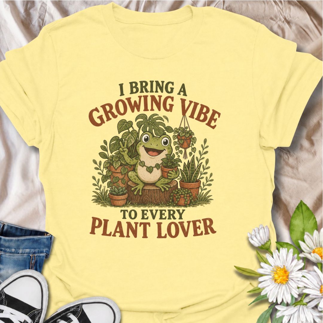 A playful plant T-shirt for anyone who brings cheerful energy wherever the houseplants are. Featuring a happy frog surrounded by lush potted plants, the phrase “I Bring a Growing Vibe to Every Plant Lover” gives the design a fun, lighthearted botanical feel. It is perfect for plant parents, houseplant collectors, indoor gardeners, and frog lovers alike. The colorful character-led artwork makes it a great gift for anyone building their own indoor jungle. Ideal for nursery trips, plant swaps, greenhouse days,