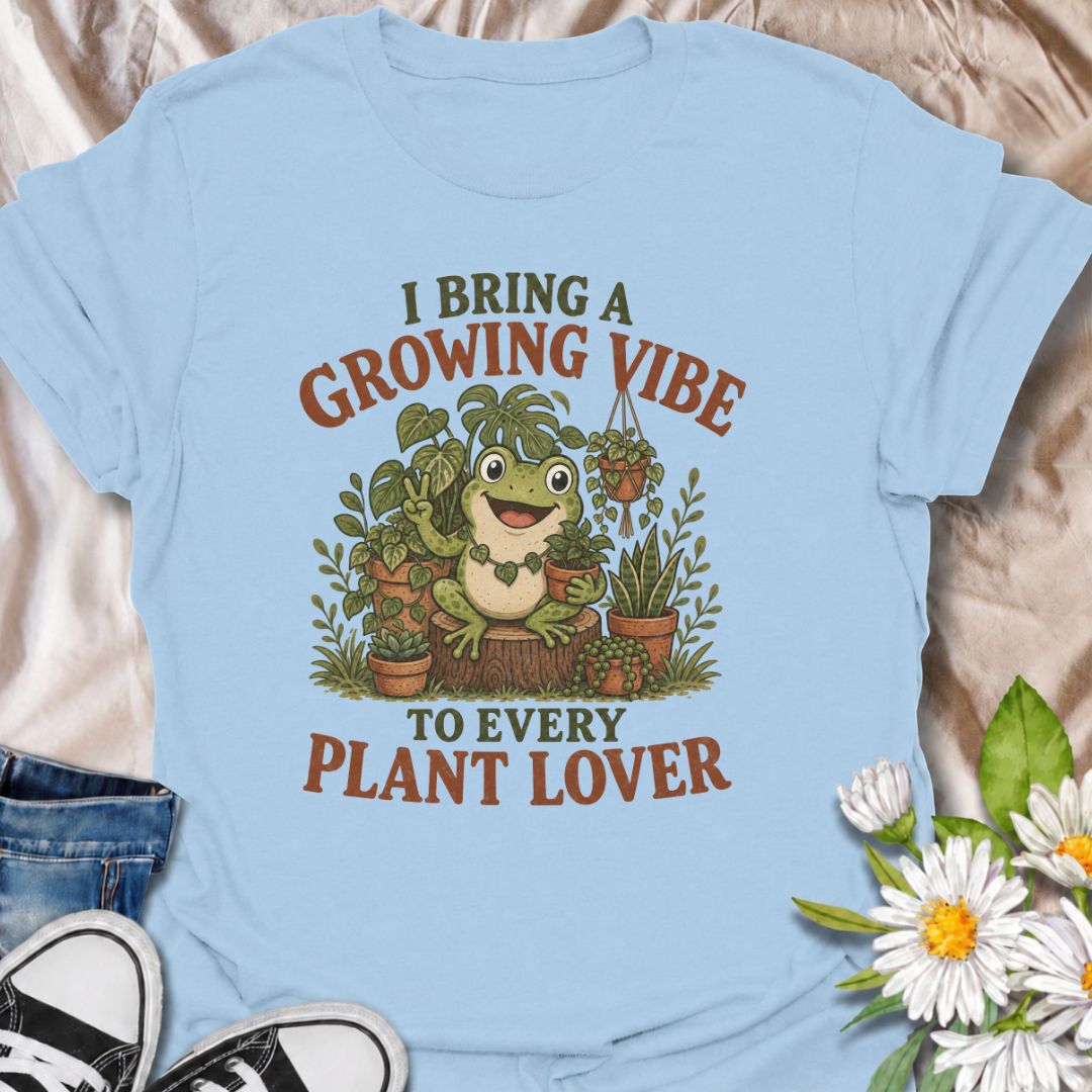 A playful plant T-shirt for anyone who brings cheerful energy wherever the houseplants are. Featuring a happy frog surrounded by lush potted plants, the phrase “I Bring a Growing Vibe to Every Plant Lover” gives the design a fun, lighthearted botanical feel. It is perfect for plant parents, houseplant collectors, indoor gardeners, and frog lovers alike. The colorful character-led artwork makes it a great gift for anyone building their own indoor jungle. Ideal for nursery trips, plant swaps, greenhouse days,
