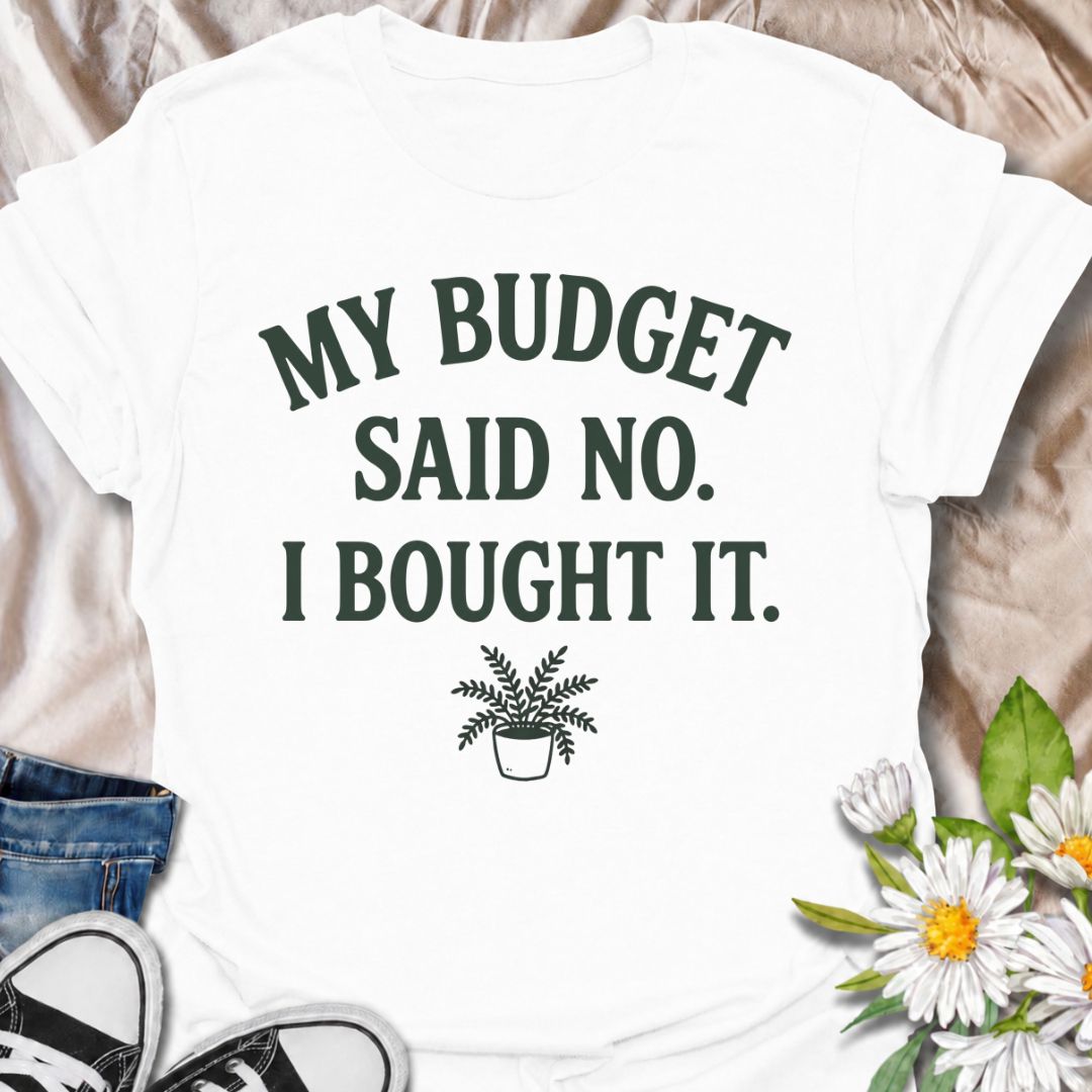A funny plant T-shirt for anyone who knows a sensible budget can disappear the moment a new plant comes into view. The phrase “My Budget Said No. I Bought It.” captures the reality of impulsive plant shopping with simple, relatable humor. Featuring a small potted plant beneath bold retro typography, the design stays clean, readable, and easy to wear. It makes a great gift for plant parents, houseplant collectors, and nursery regulars who can never resist one more purchase. Perfect for plant swaps, garden ce