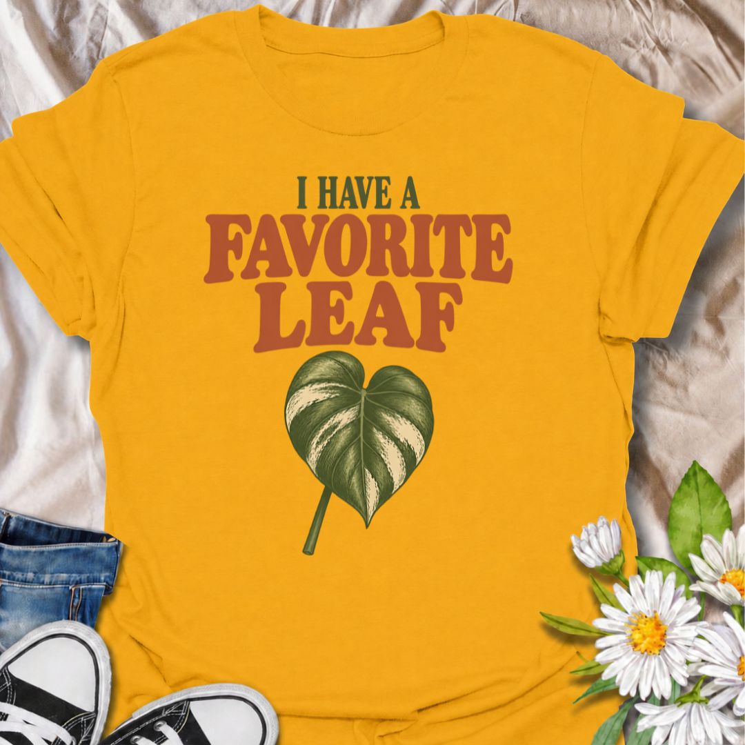 A playful plant T-shirt for anyone who definitely has a favorite leaf and is not afraid to admit it. The phrase “I Have a Favorite Leaf” pairs with a single variegated leaf for a simple, plant-lover design with just the right amount of personality. It is perfect for houseplant collectors, variegated plant fans, indoor gardeners, and anyone who notices every new leaf as it unfurls. The clean layout makes it easy to wear while still feeling distinctly niche. A great gift for plant parents, pothos lovers, phil