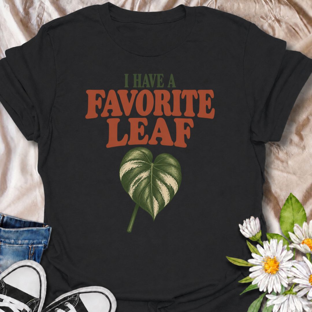 A playful plant T-shirt for anyone who definitely has a favorite leaf and is not afraid to admit it. The phrase “I Have a Favorite Leaf” pairs with a single variegated leaf for a simple, plant-lover design with just the right amount of personality. It is perfect for houseplant collectors, variegated plant fans, indoor gardeners, and anyone who notices every new leaf as it unfurls. The clean layout makes it easy to wear while still feeling distinctly niche. A great gift for plant parents, pothos lovers, phil