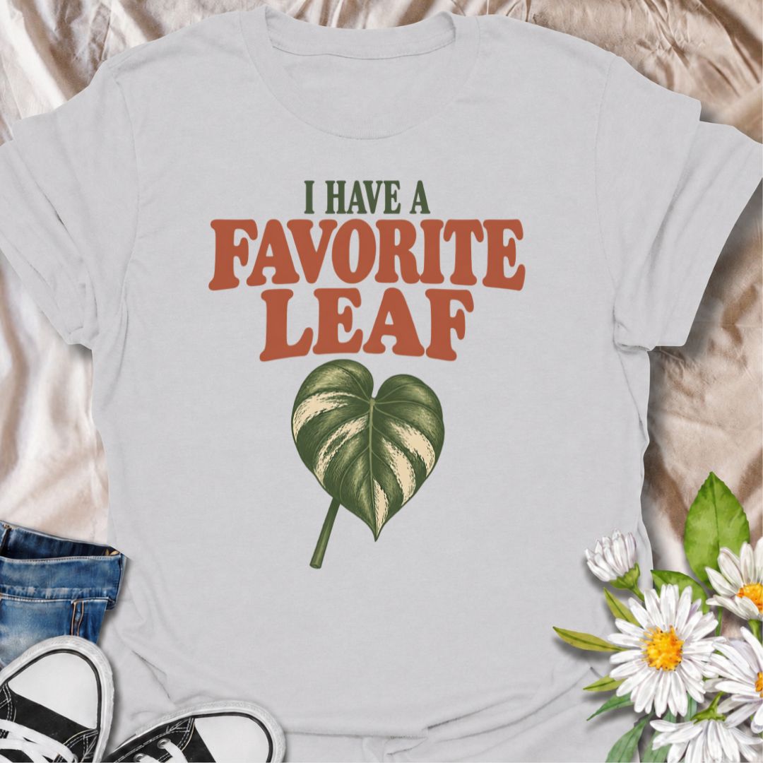 A playful plant T-shirt for anyone who definitely has a favorite leaf and is not afraid to admit it. The phrase “I Have a Favorite Leaf” pairs with a single variegated leaf for a simple, plant-lover design with just the right amount of personality. It is perfect for houseplant collectors, variegated plant fans, indoor gardeners, and anyone who notices every new leaf as it unfurls. The clean layout makes it easy to wear while still feeling distinctly niche. A great gift for plant parents, pothos lovers, phil