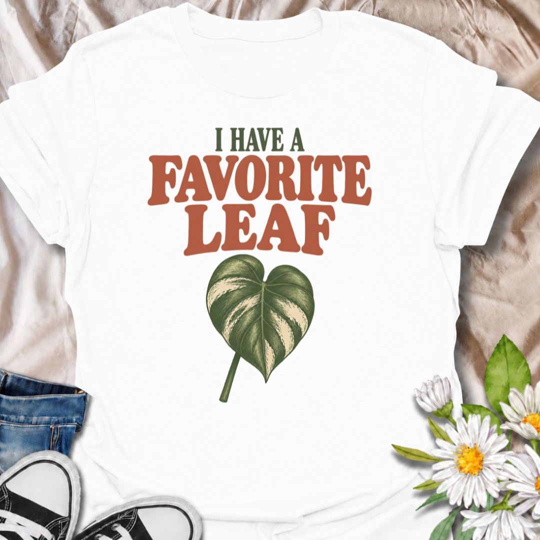 A playful plant T-shirt for anyone who definitely has a favorite leaf and is not afraid to admit it. The phrase “I Have a Favorite Leaf” pairs with a single variegated leaf for a simple, plant-lover design with just the right amount of personality. It is perfect for houseplant collectors, variegated plant fans, indoor gardeners, and anyone who notices every new leaf as it unfurls. The clean layout makes it easy to wear while still feeling distinctly niche. A great gift for plant parents, pothos lovers, phil