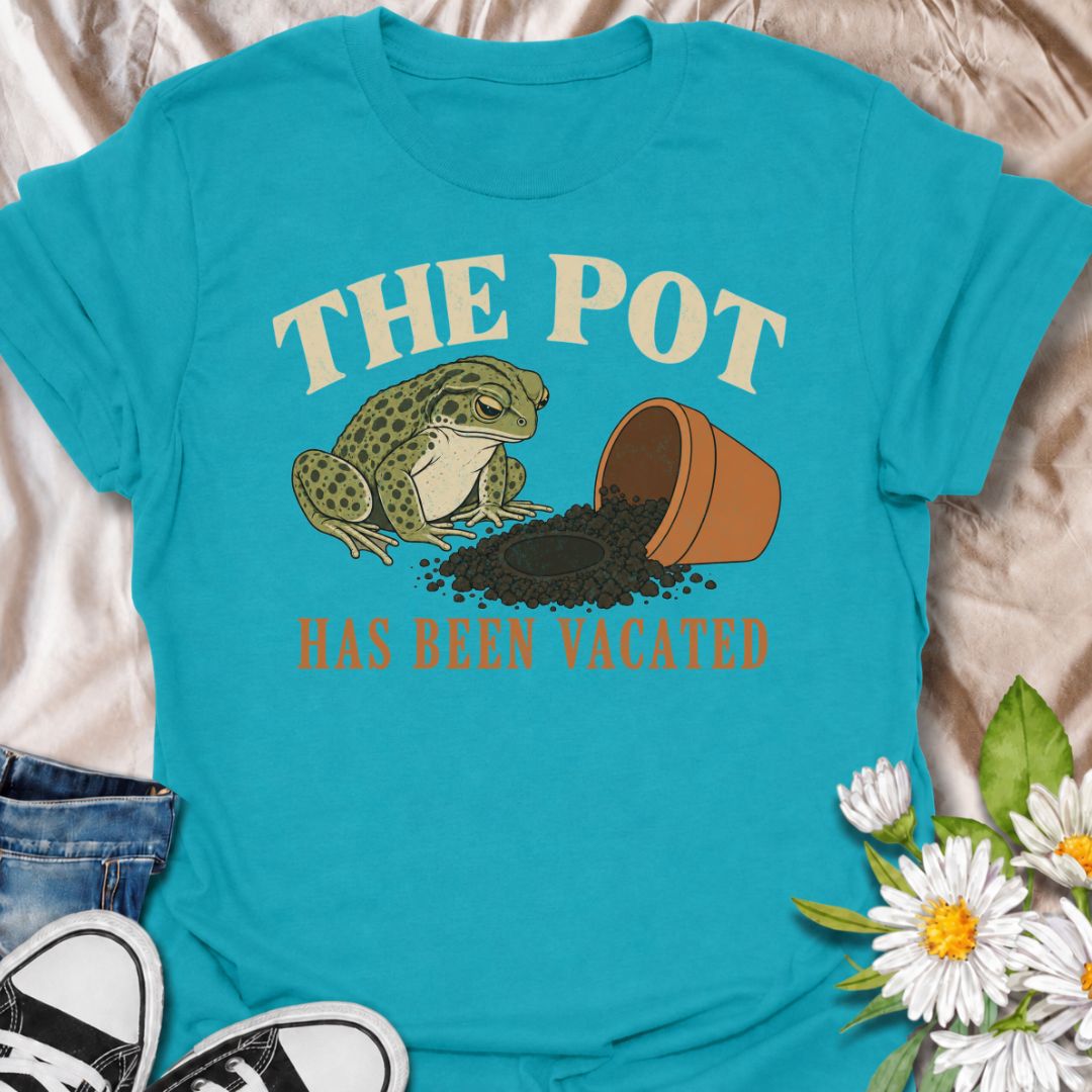 A funny plant T-shirt for anyone who knows an empty pot never stays empty for long. Featuring a deadpan frog beside an overturned planter and a suspiciously vacant patch of soil, this design gives “The Pot Has Been Vacated” a dry, slightly absurd sense of humor. It is perfect for houseplant lovers, plant parents, gardeners, and anyone who treats an empty pot as an invitation to buy something new. The vintage-style illustration makes it feel distinctive while still being easy to wear. A fun gift for plant co