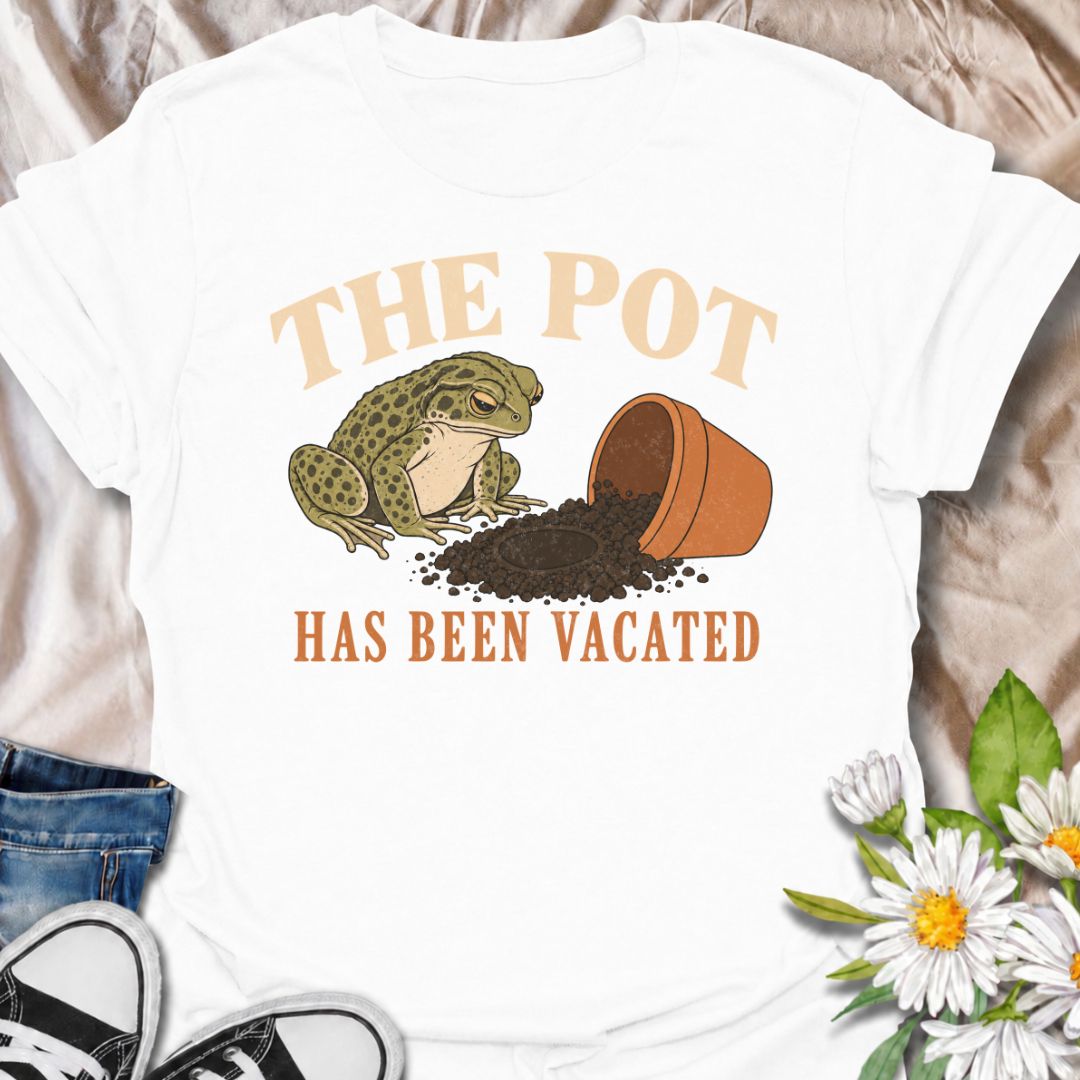 A funny plant T-shirt for anyone who knows an empty pot never stays empty for long. Featuring a deadpan frog beside an overturned planter and a suspiciously vacant patch of soil, this design gives “The Pot Has Been Vacated” a dry, slightly absurd sense of humor. It is perfect for houseplant lovers, plant parents, gardeners, and anyone who treats an empty pot as an invitation to buy something new. The vintage-style illustration makes it feel distinctive while still being easy to wear. A fun gift for plant co