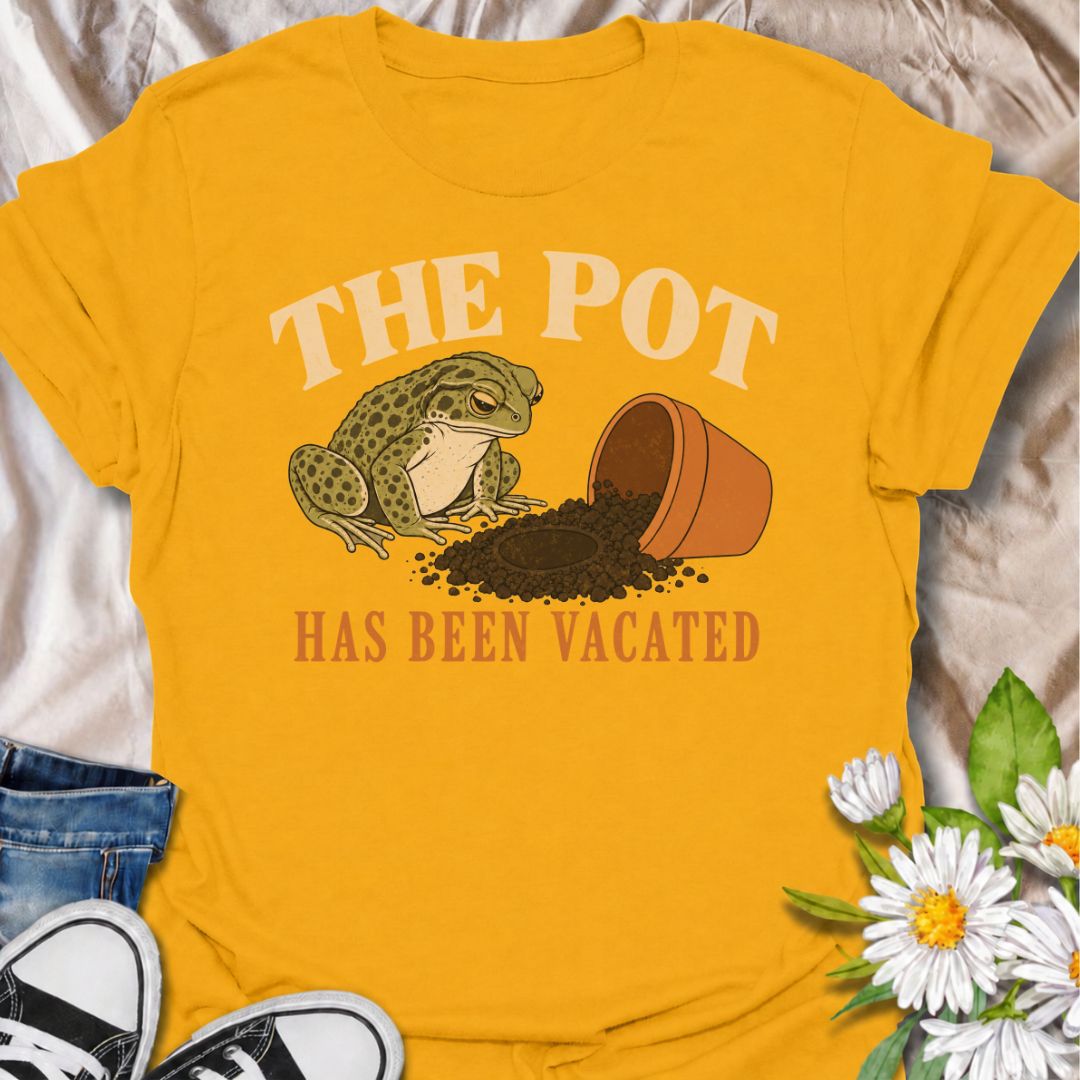 A funny plant T-shirt for anyone who knows an empty pot never stays empty for long. Featuring a deadpan frog beside an overturned planter and a suspiciously vacant patch of soil, this design gives “The Pot Has Been Vacated” a dry, slightly absurd sense of humor. It is perfect for houseplant lovers, plant parents, gardeners, and anyone who treats an empty pot as an invitation to buy something new. The vintage-style illustration makes it feel distinctive while still being easy to wear. A fun gift for plant co