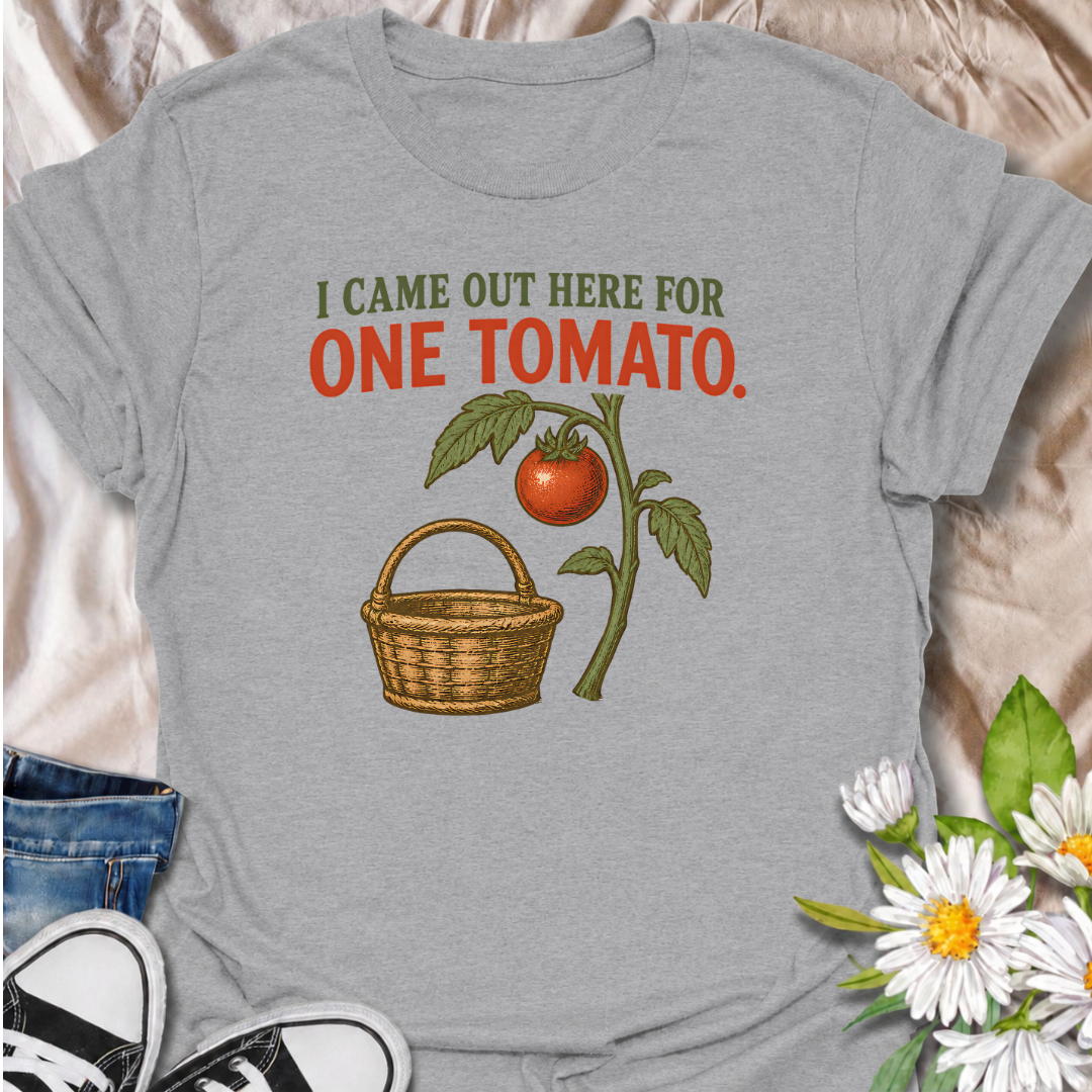 A funny gardening T-shirt for anyone who heads outside for one tomato and somehow gets distracted by everything else in the garden. The phrase “I Came Out Here for One Tomato” captures that familiar backyard-gardener moment with simple, relatable humor. Featuring a ripe tomato on the vine and a vintage-style harvest basket, the design feels warm, rustic, and easy to wear. It makes a great gift for tomato growers, vegetable gardeners, and anyone who spends harvest season wandering around the garden. Ideal fo