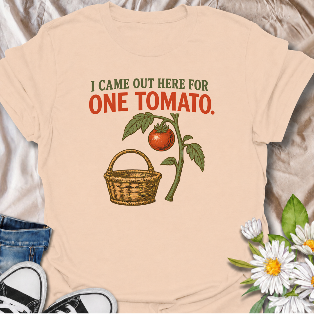 A funny gardening T-shirt for anyone who heads outside for one tomato and somehow gets distracted by everything else in the garden. The phrase “I Came Out Here for One Tomato” captures that familiar backyard-gardener moment with simple, relatable humor. Featuring a ripe tomato on the vine and a vintage-style harvest basket, the design feels warm, rustic, and easy to wear. It makes a great gift for tomato growers, vegetable gardeners, and anyone who spends harvest season wandering around the garden. Ideal fo