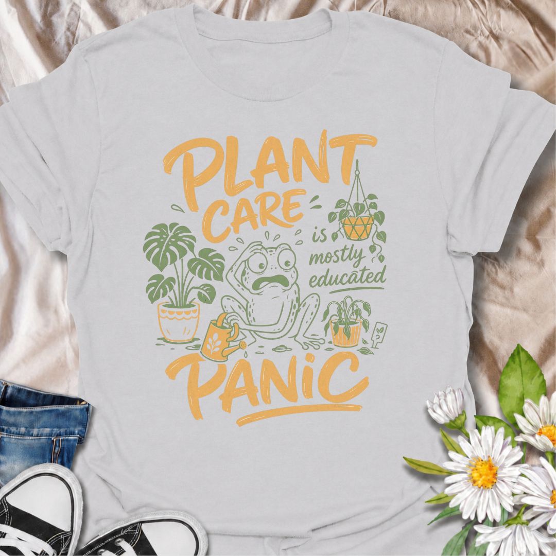 A funny plant T-shirt for anyone who has read all the care guides and still panics when a leaf starts looking slightly different. The phrase “Plant Care Is Mostly Educated Panic” perfectly captures the reality of houseplant ownership with playful, relatable humor. Featuring a worried frog surrounded by potted plants, a watering can, and plant-care chaos, this design is ideal for plant parents, indoor gardeners, and houseplant collectors. It makes a great gift for anyone who checks the soil twice, Googles ye