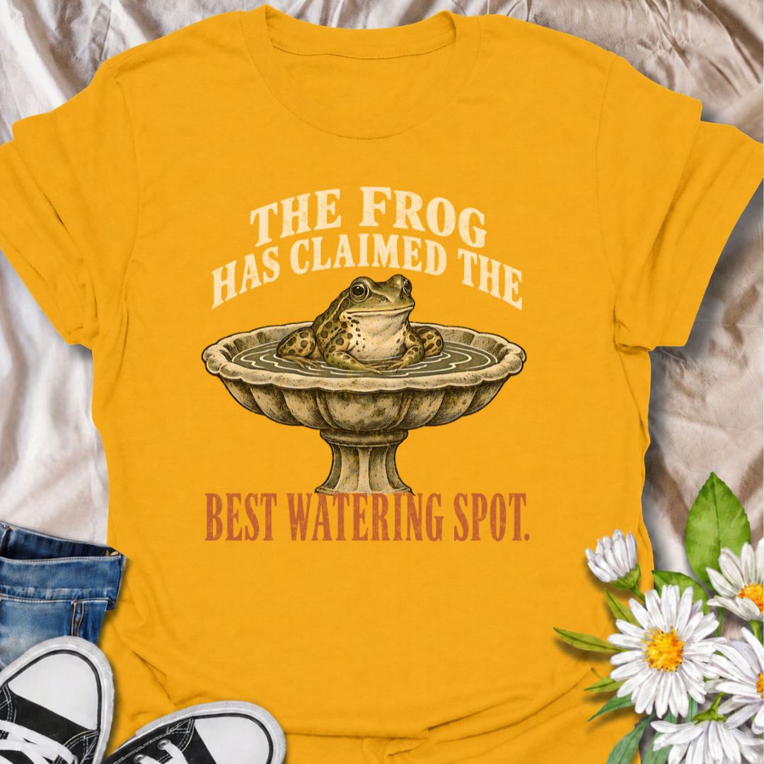 A funny gardening T-shirt for anyone whose garden wildlife has decided certain spots now belong to them. The phrase “The Frog Has Claimed the Best Watering Spot” pairs perfectly with a content-looking frog sitting in a birdbath for dry, relatable garden humor. It is ideal for backyard gardeners, wildlife gardeners, frog lovers, and anyone who enjoys seeing unexpected visitors around the garden. The vintage-style illustration gives the design personality while keeping it easy to wear. A great gift for garden