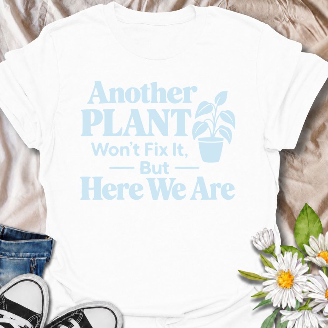 A funny plant T-shirt for anyone who knows buying another houseplant probably will not solve the problem—but does it anyway. The phrase “Another Plant Won’t Fix It, But Here We Are” delivers dry, self-aware humor that plant parents and collectors will instantly understand. Featuring bold typography with a simple potted plant graphic, the design stays clean, readable, and easy to wear. It makes a great gift for houseplant lovers, nursery regulars, and anyone whose indoor jungle keeps growing despite their be
