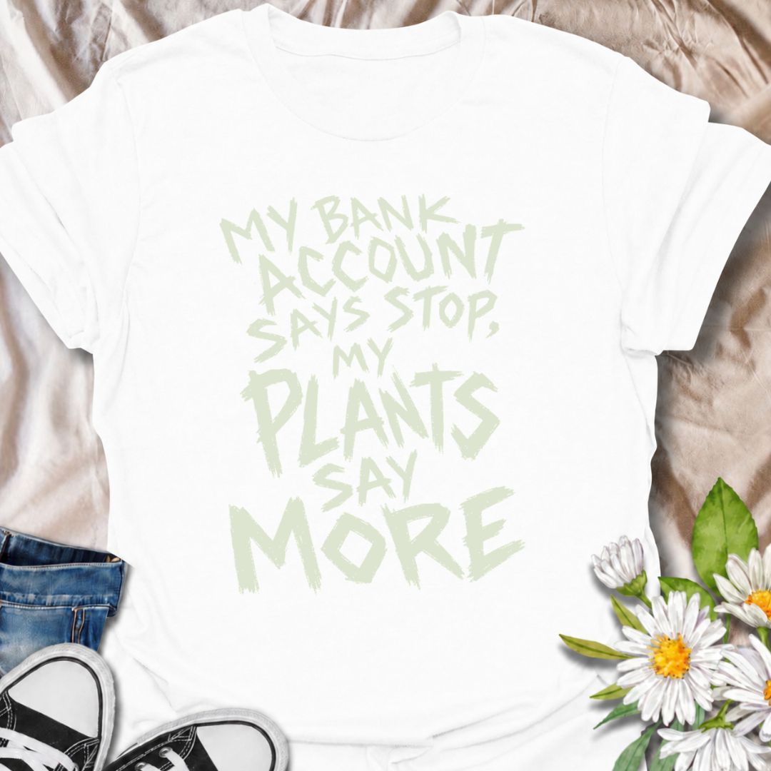 A funny plant T-shirt for anyone whose budget says stop but whose houseplant collection has other ideas. The phrase “My Bank Account Says Stop, My Plants Say More” delivers relatable plant-shopping humor for collectors who can never quite resist another plant. Its bold hand-drawn typography gives the design an expressive, slightly chaotic feel that suits the joke perfectly. It makes a great gift for plant parents, nursery regulars, and anyone whose indoor jungle keeps growing faster than their savings. Perf