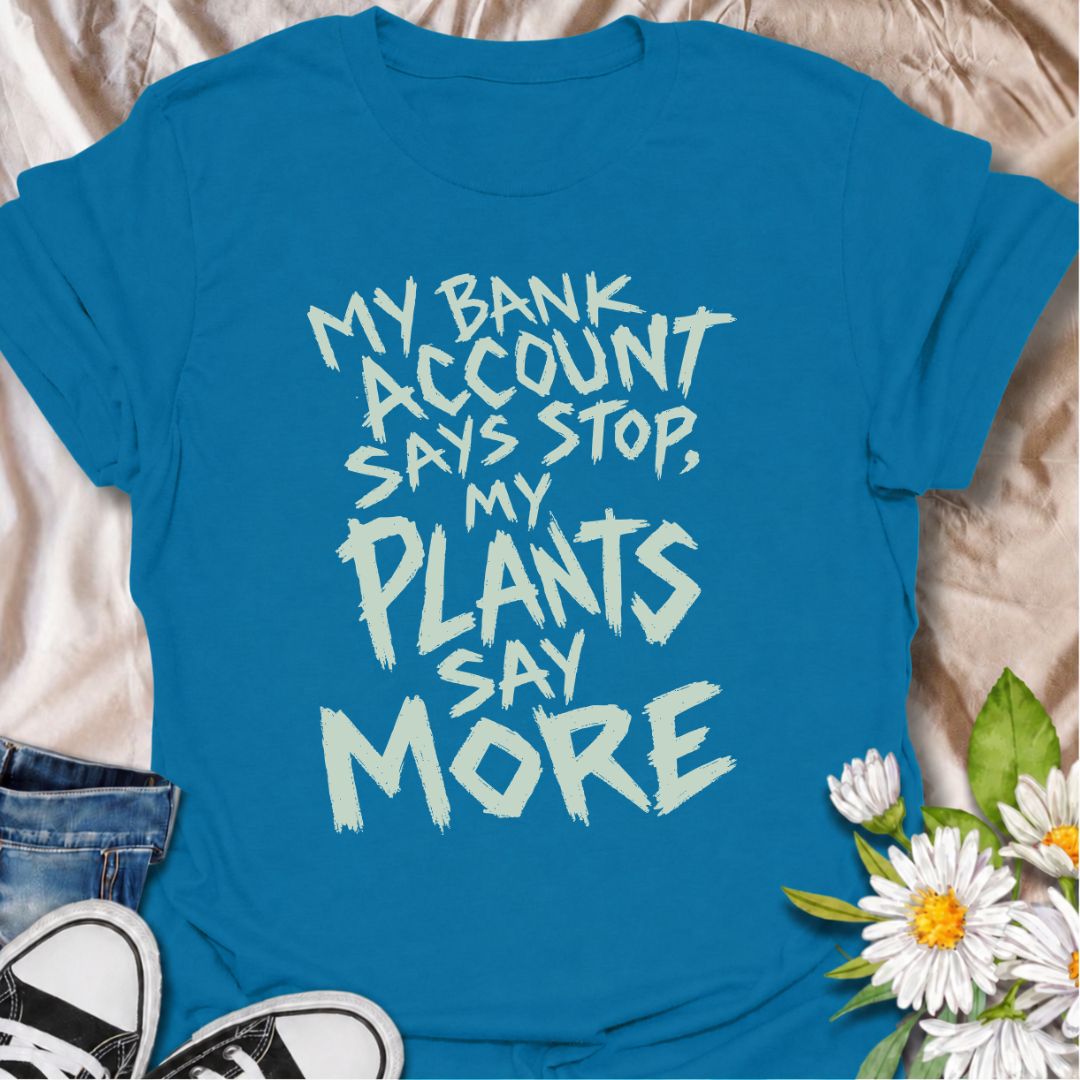 A funny plant T-shirt for anyone whose budget says stop but whose houseplant collection has other ideas. The phrase “My Bank Account Says Stop, My Plants Say More” delivers relatable plant-shopping humor for collectors who can never quite resist another plant. Its bold hand-drawn typography gives the design an expressive, slightly chaotic feel that suits the joke perfectly. It makes a great gift for plant parents, nursery regulars, and anyone whose indoor jungle keeps growing faster than their savings. Perf