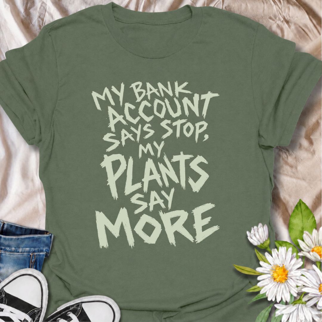 A funny plant T-shirt for anyone whose budget says stop but whose houseplant collection has other ideas. The phrase “My Bank Account Says Stop, My Plants Say More” delivers relatable plant-shopping humor for collectors who can never quite resist another plant. Its bold hand-drawn typography gives the design an expressive, slightly chaotic feel that suits the joke perfectly. It makes a great gift for plant parents, nursery regulars, and anyone whose indoor jungle keeps growing faster than their savings. Perf
