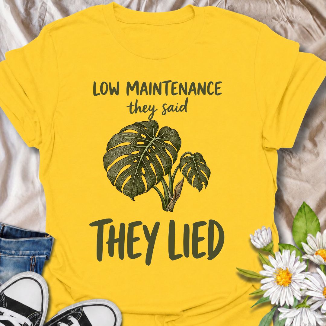 A funny plant T-shirt for anyone who was promised an easy-care houseplant and quickly discovered otherwise. The phrase “Low Maintenance, They Said. They Lied.” delivers dry, relatable humor that plant parents and monstera lovers will instantly understand. Featuring a leafy monstera illustration, the design feels simple, wearable, and clearly rooted in houseplant culture. It makes a great gift for indoor gardeners, plant collectors, and anyone who has spent far more time troubleshooting a supposedly easy pla