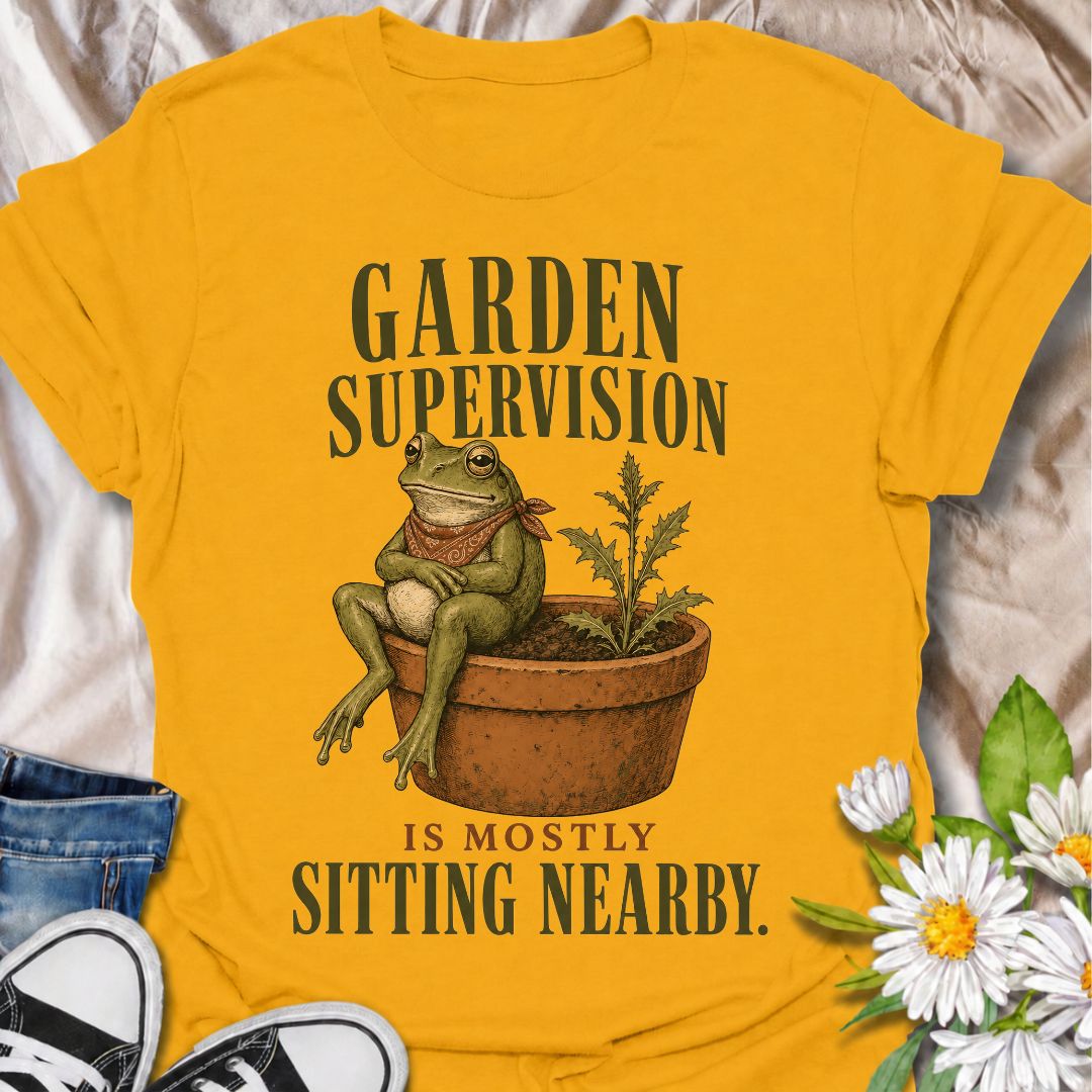 A funny gardening T-shirt for anyone who knows that supervising the garden often means sitting nearby and keeping an eye on things. The phrase “Garden Supervision Is Mostly Sitting Nearby” pairs perfectly with a deadpan frog perched beside a potted weed for dry, character-led garden humor. It is ideal for backyard gardeners, plant lovers, frog fans, and anyone who spends plenty of time simply observing what is growing. The vintage-style illustration gives the design personality while keeping it easy to wear