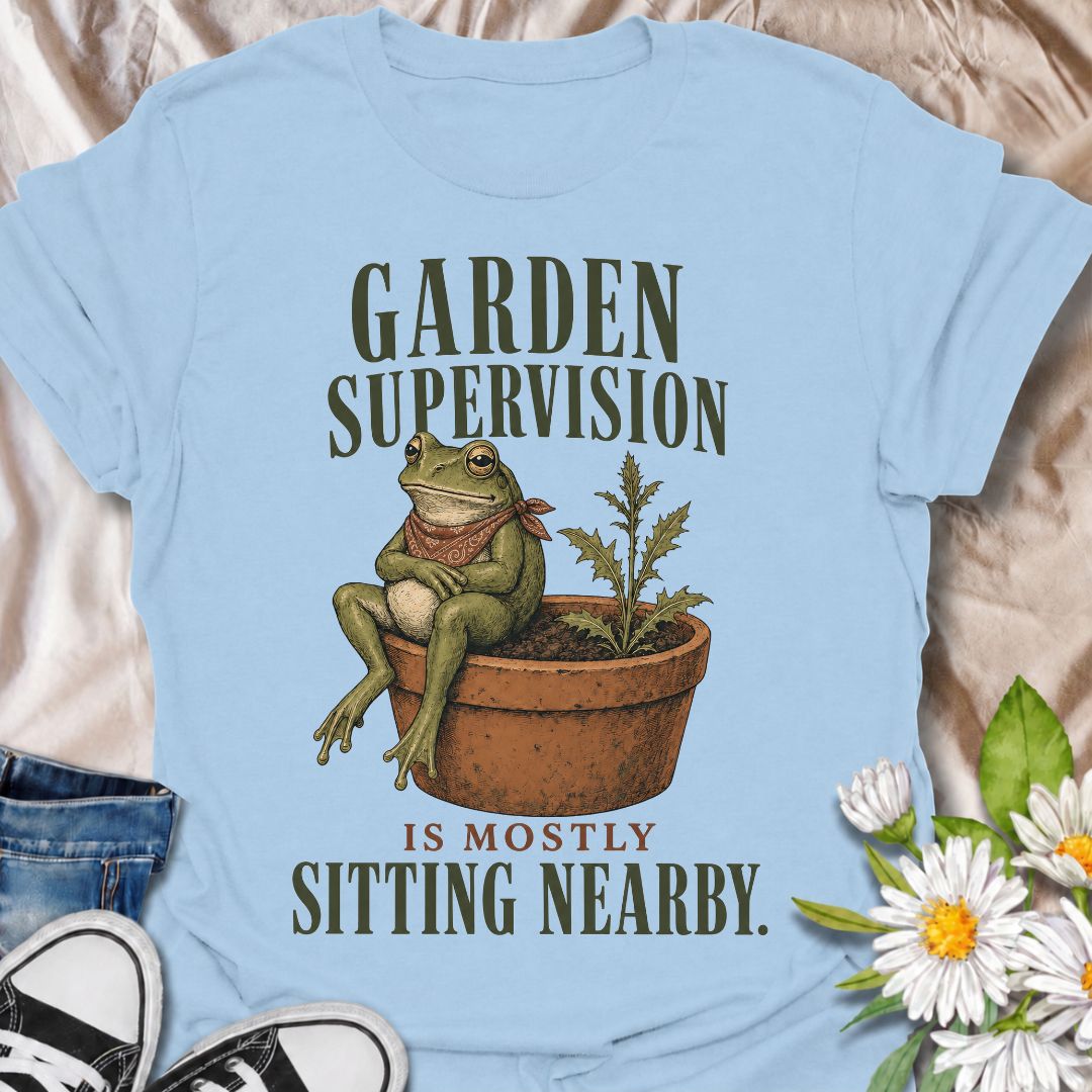 A funny gardening T-shirt for anyone who knows that supervising the garden often means sitting nearby and keeping an eye on things. The phrase “Garden Supervision Is Mostly Sitting Nearby” pairs perfectly with a deadpan frog perched beside a potted weed for dry, character-led garden humor. It is ideal for backyard gardeners, plant lovers, frog fans, and anyone who spends plenty of time simply observing what is growing. The vintage-style illustration gives the design personality while keeping it easy to wear