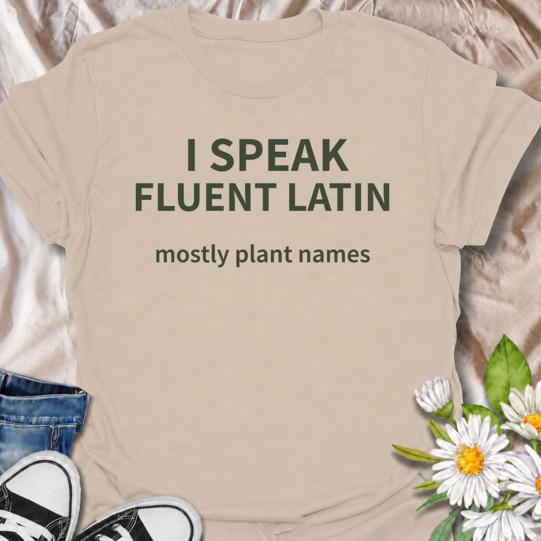 A funny plant T-shirt for gardeners who know more botanical Latin than they ever expected to learn. The phrase “I Speak Fluent Latin — Mostly Plant Names” delivers clever, niche humor for plant lovers, gardeners, and anyone who casually drops scientific plant names into conversation. Its clean typography keeps the design simple, readable, and easy to wear. It makes a great gift for horticulture fans, houseplant collectors, flower gardeners, and serious plant nerds. Perfect for nursery trips, garden centers,