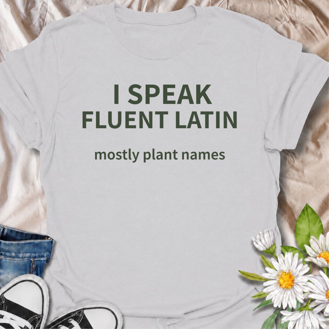 A funny plant T-shirt for gardeners who know more botanical Latin than they ever expected to learn. The phrase “I Speak Fluent Latin — Mostly Plant Names” delivers clever, niche humor for plant lovers, gardeners, and anyone who casually drops scientific plant names into conversation. Its clean typography keeps the design simple, readable, and easy to wear. It makes a great gift for horticulture fans, houseplant collectors, flower gardeners, and serious plant nerds. Perfect for nursery trips, garden centers,