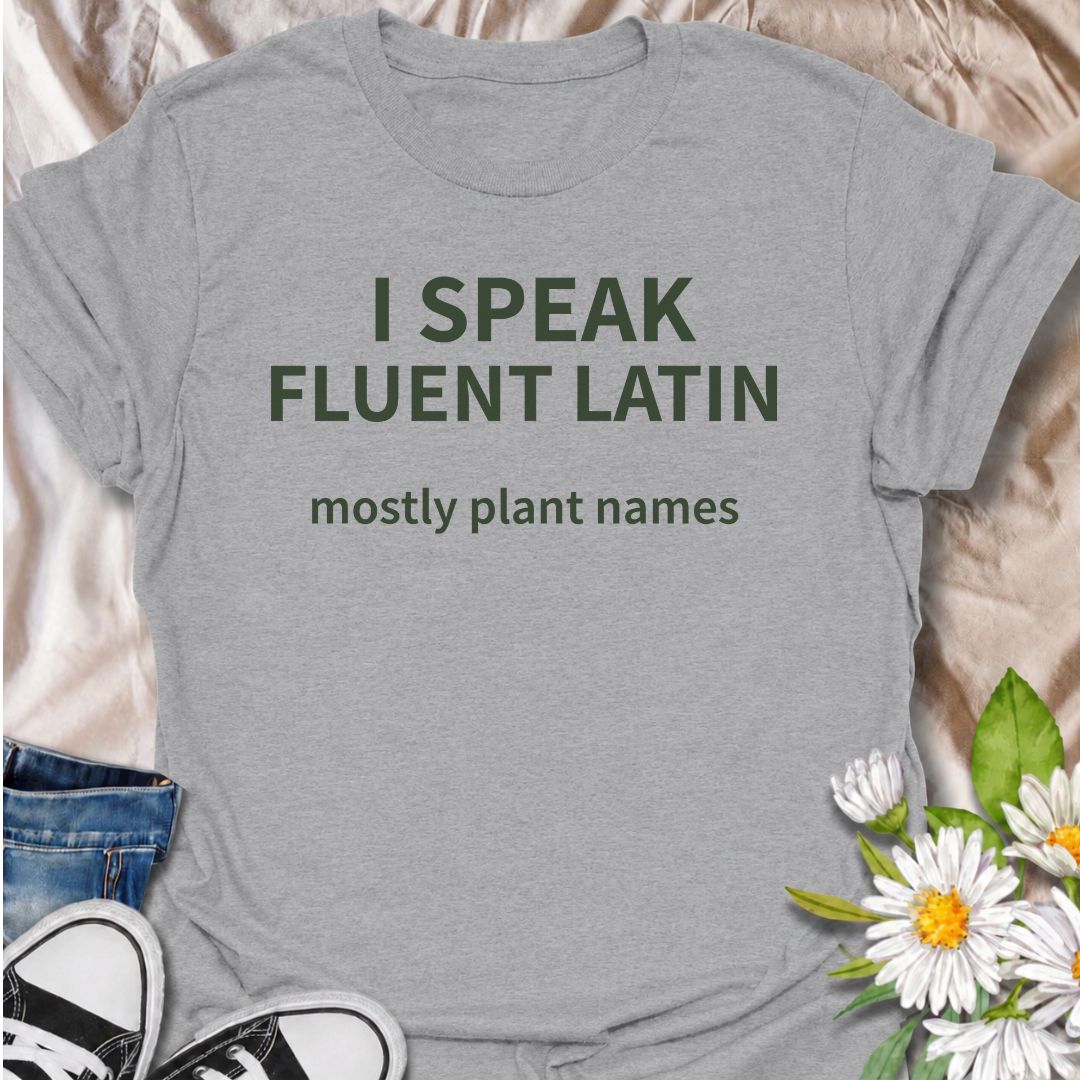 A funny plant T-shirt for gardeners who know more botanical Latin than they ever expected to learn. The phrase “I Speak Fluent Latin — Mostly Plant Names” delivers clever, niche humor for plant lovers, gardeners, and anyone who casually drops scientific plant names into conversation. Its clean typography keeps the design simple, readable, and easy to wear. It makes a great gift for horticulture fans, houseplant collectors, flower gardeners, and serious plant nerds. Perfect for nursery trips, garden centers,