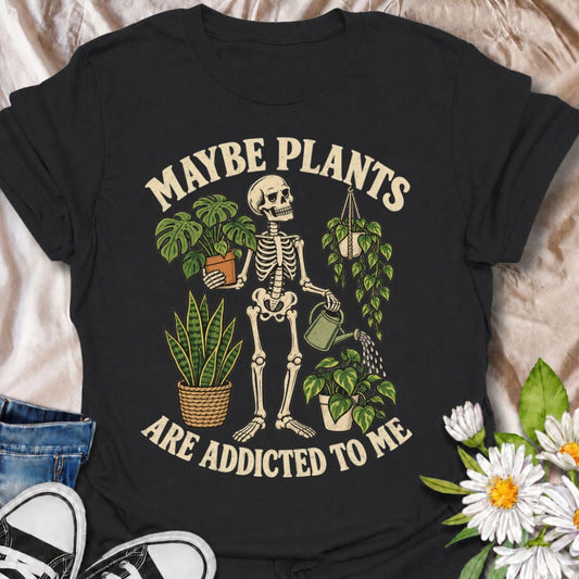 A funny plant T-shirt for anyone who insists the obsession works both ways. The phrase “Maybe Plants Are Addicted to Me” pairs with a skeleton surrounded by houseplants and a watering can for dark, playful plant-parent humor. It is perfect for houseplant lovers, indoor gardeners, plant collectors, and anyone whose home is steadily turning into an indoor jungle. The vintage-style skeleton artwork gives the design plenty of personality while keeping it firmly in the botanical niche. A great gift for plant lov