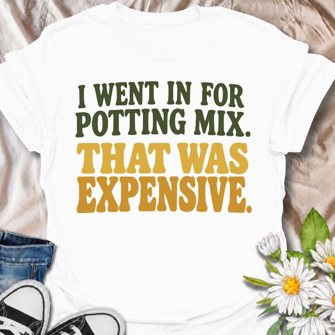 A funny plant T-shirt for anyone who went to the garden center for one bag of potting mix and somehow spent far more than planned. The phrase “I Went In for Potting Mix. That Was Expensive.” delivers dry, relatable humor for plant parents, houseplant collectors, and nursery regulars. Its bold retro typography keeps the design simple, readable, and easy to wear. It makes a great gift for plant lovers who know a “quick trip” for supplies rarely stays cheap. Perfect for nursery visits, garden centers, plant sw