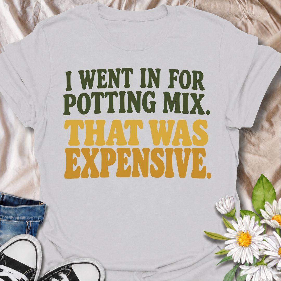 A funny plant T-shirt for anyone who went to the garden center for one bag of potting mix and somehow spent far more than planned. The phrase “I Went In for Potting Mix. That Was Expensive.” delivers dry, relatable humor for plant parents, houseplant collectors, and nursery regulars. Its bold retro typography keeps the design simple, readable, and easy to wear. It makes a great gift for plant lovers who know a “quick trip” for supplies rarely stays cheap. Perfect for nursery visits, garden centers, plant sw