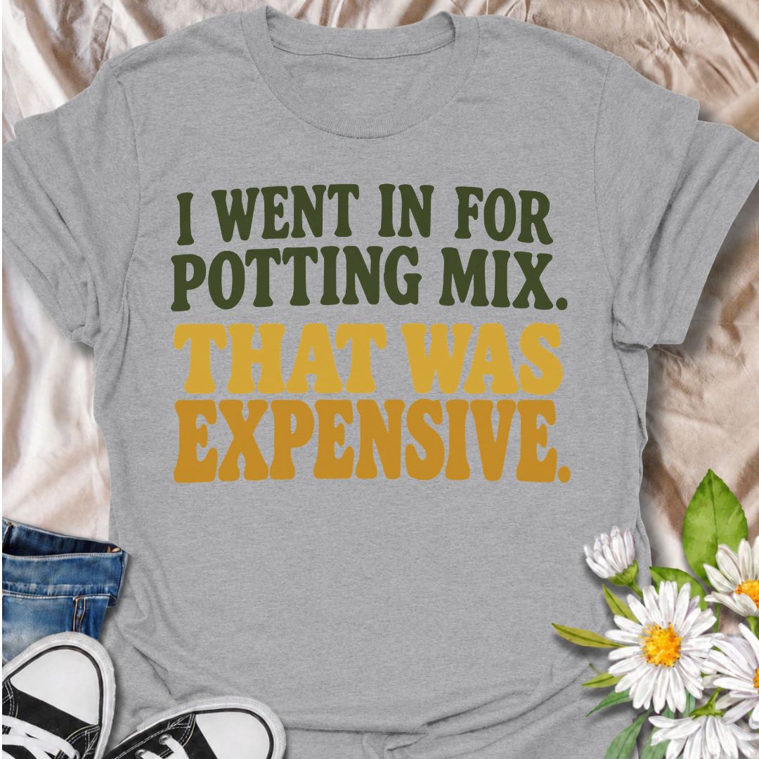 A funny plant T-shirt for anyone who went to the garden center for one bag of potting mix and somehow spent far more than planned. The phrase “I Went In for Potting Mix. That Was Expensive.” delivers dry, relatable humor for plant parents, houseplant collectors, and nursery regulars. Its bold retro typography keeps the design simple, readable, and easy to wear. It makes a great gift for plant lovers who know a “quick trip” for supplies rarely stays cheap. Perfect for nursery visits, garden centers, plant sw