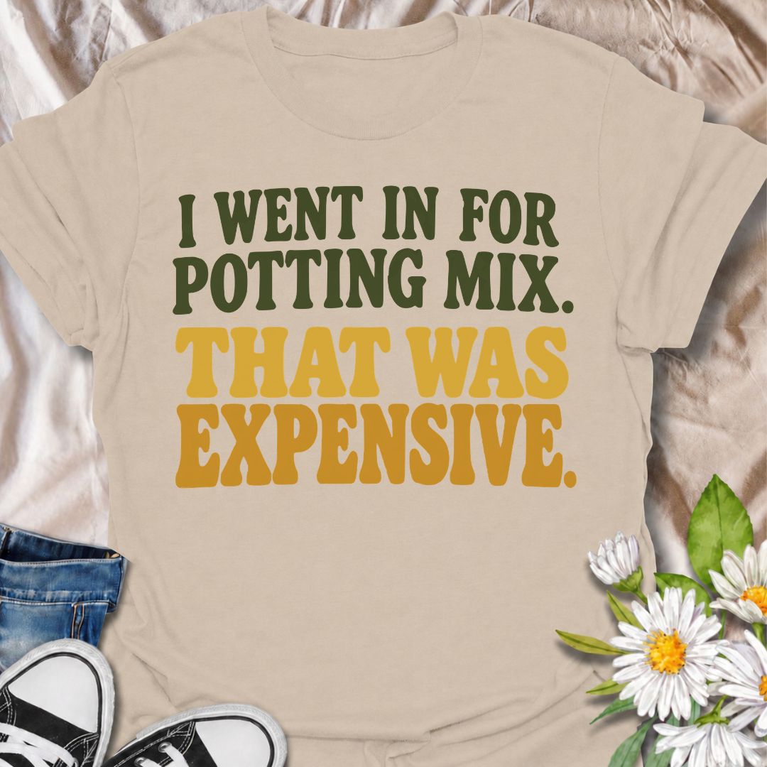 A funny plant T-shirt for anyone who went to the garden center for one bag of potting mix and somehow spent far more than planned. The phrase “I Went In for Potting Mix. That Was Expensive.” delivers dry, relatable humor for plant parents, houseplant collectors, and nursery regulars. Its bold retro typography keeps the design simple, readable, and easy to wear. It makes a great gift for plant lovers who know a “quick trip” for supplies rarely stays cheap. Perfect for nursery visits, garden centers, plant sw